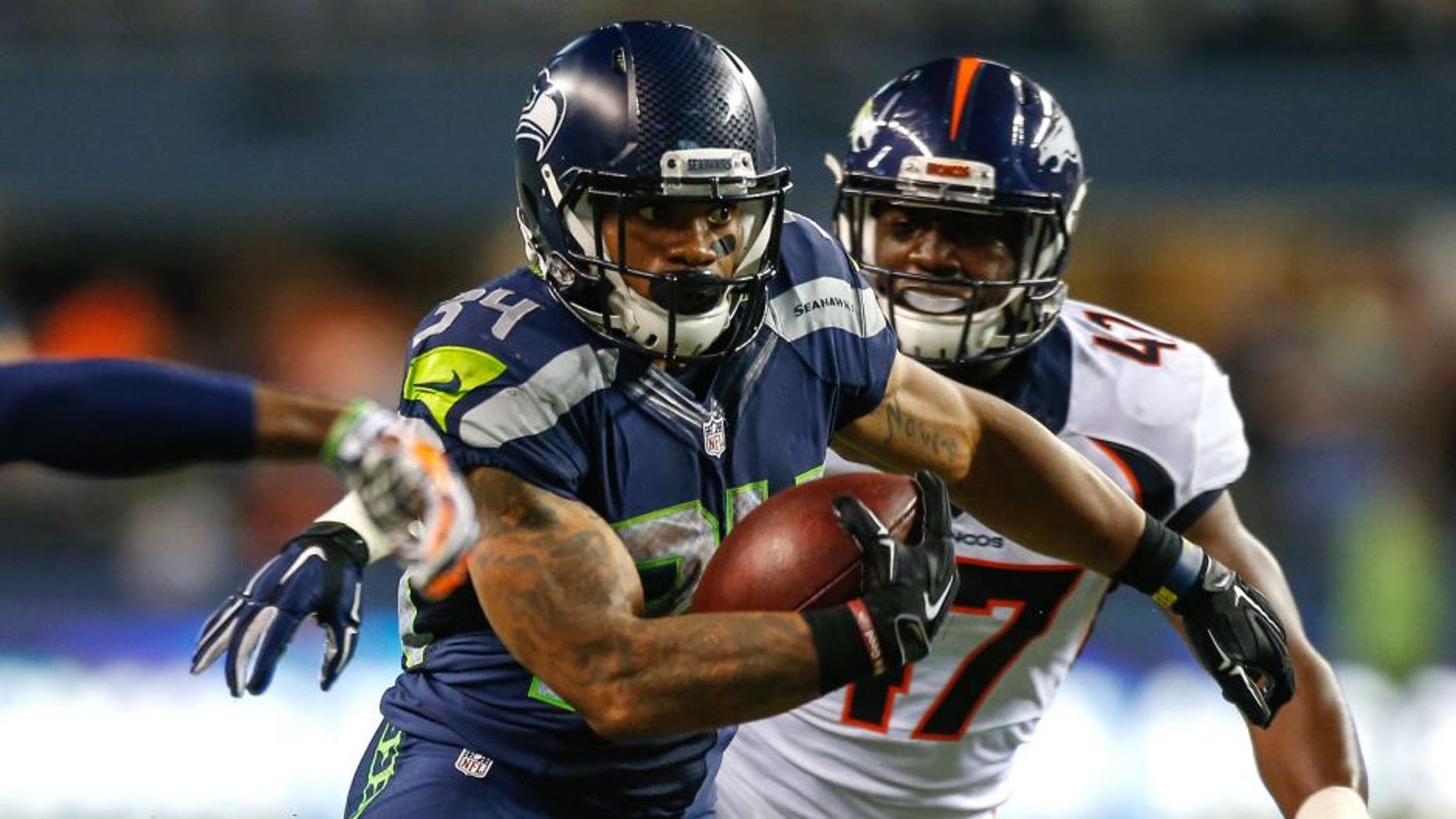SEATTLE, WA - AUGUST 14: Running back Thomas Rawls #34 of the Seattle Seahawks rushes for a touchdown in the fourth quarter against the Denver Broncos at CenturyLink Field on August 14, 2015 in Seattle, Washington. The Broncos defeated the Seahawks 22-20. (Photo by Otto Greule Jr/Getty Images)