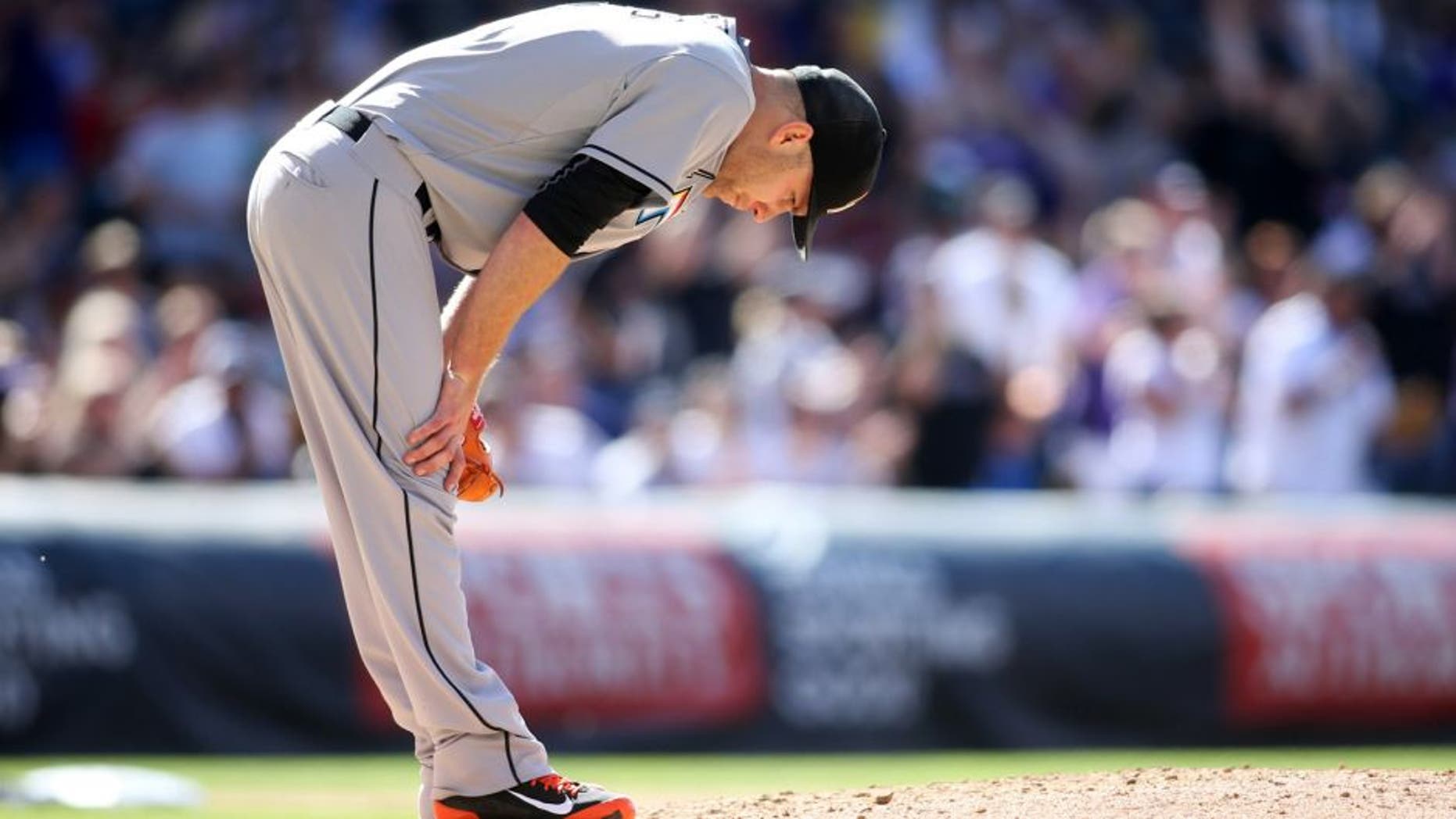 Jun 6, 2015; Denver, CO, USA; Miami Marlins starting pitcher David Phelps (41) reacts after Colorado Rockies right fielder Carlos Gonzalez (5) hit a home run during the fourth inning at Coors Field. Mandatory Credit: Chris Humphreys-USA TODAY Sports