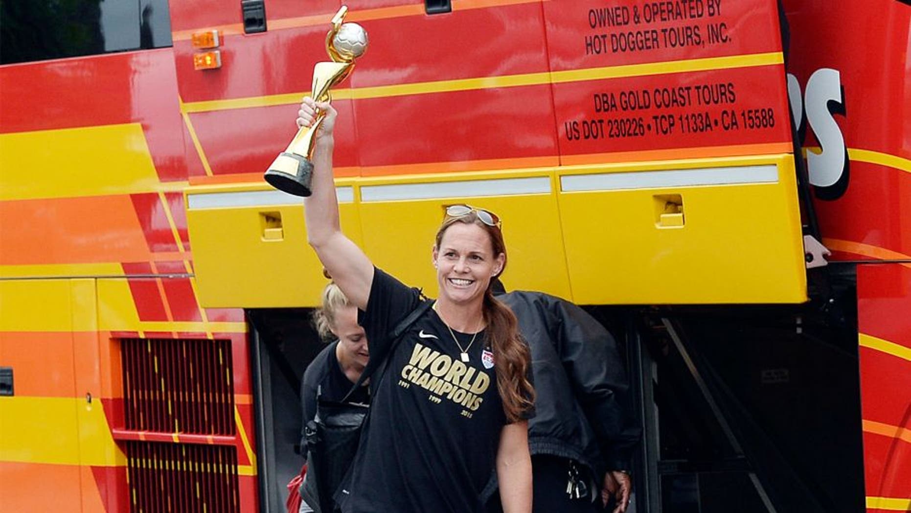 LOS ANGELES, CA - JULY 6: Captain Christie Rampone holds the FIFA Women's World Cup trophy as she walks to the bus after arriving at Los Angeles International Airport July 6, 2015 in Los Angeles, California. (Photo by Kevork Djansezian/Getty Images)