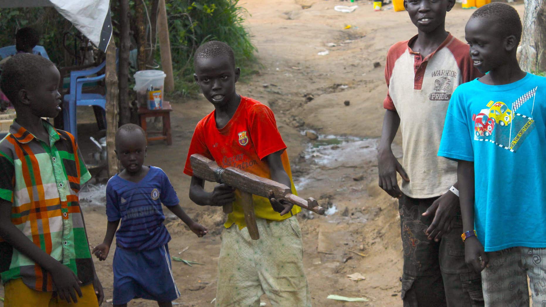 In this Monday, July 25, 2016 photo, a group of children at the U.N. protection of Civilians site in Juba, South Sudan, play with a makeshift gun.