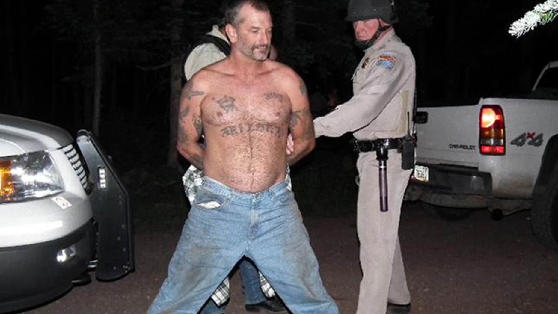 Aug. 19: In this photo provided by the U.S. Marshals Service, fugitive John McCluskey is shown being taken into custody by U.S. Marshals in eastern Arizona. McCluskey and his fiancee Casslyn Welch had been on the run since July 30.