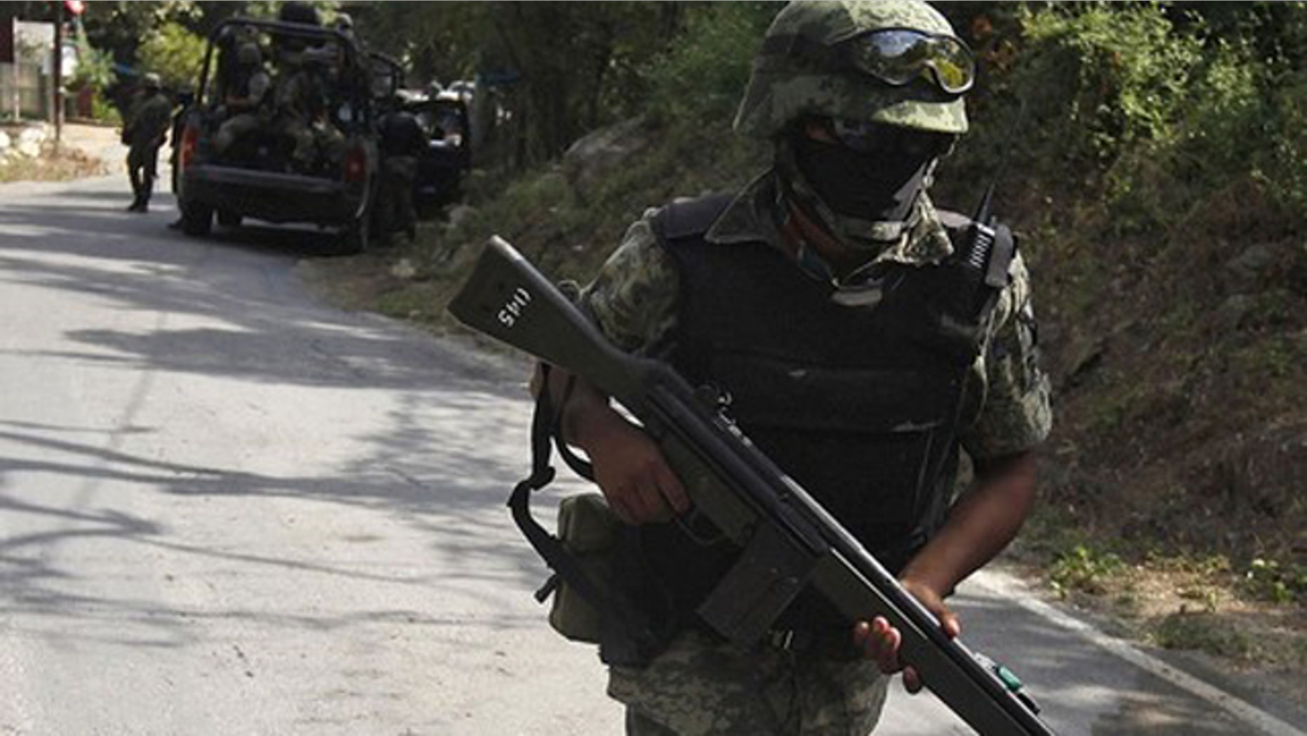 Aug. 18: Mexican soldiers arrive to secure a crime scene where where the body of Edelmiro Cavazos, mayor of the tourist town of Santiago, was found on a local road in the municipality of Santiago, some 18.6 miles away from Monterrey.