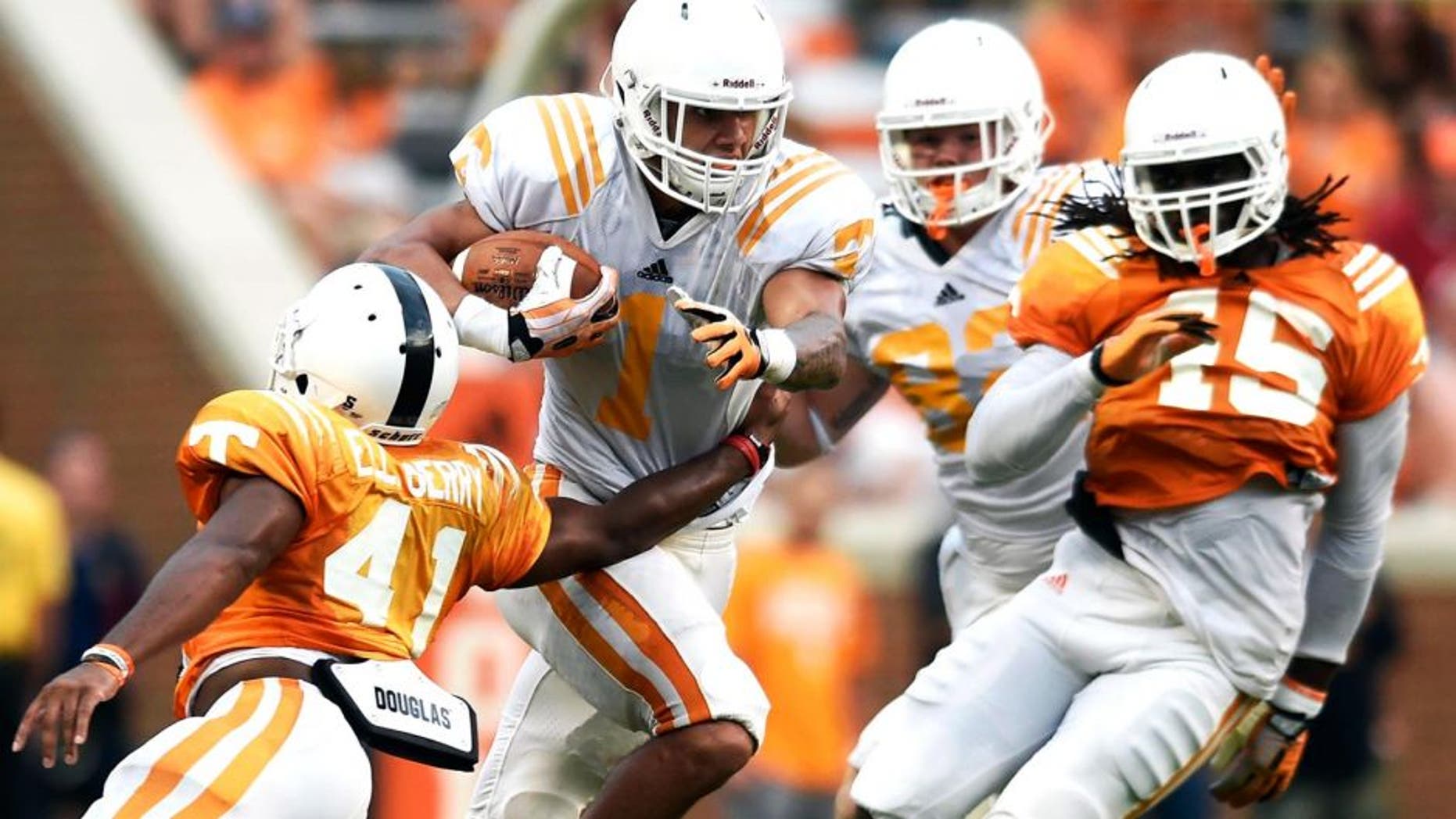 Tennessee running back Jalen Hurd (1) breaks a tackle by Tennessee defensive back Elliott Berry (41) during Tennessee's open practice at Neyland Stadium in Knoxville on Saturday, Aug. 16, 2014. (AP Photo/Knoxville News Sentinel, Adam Lau)