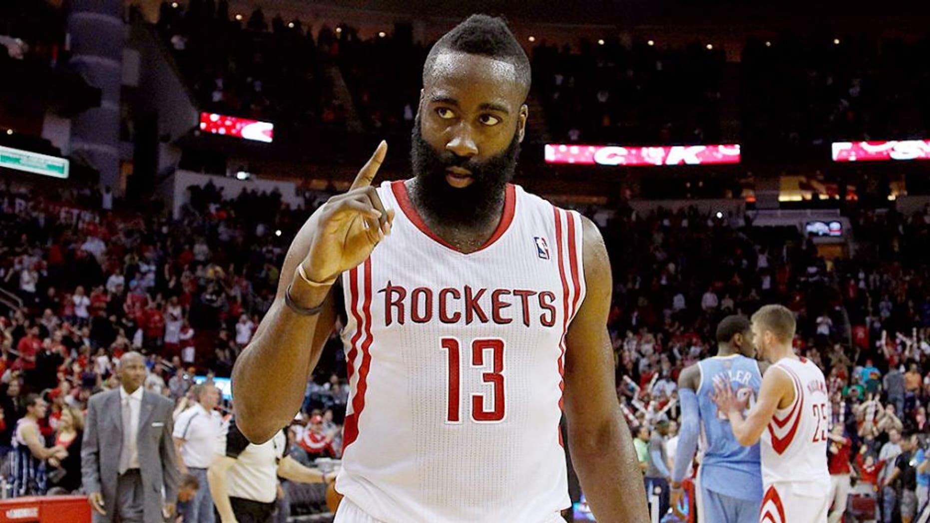 Apr 6, 2014; Houston, TX, USA; Houston Rockets guard James Harden (13) holds up one finger following the Houston Rockets 130-125 overtime win against the Denver Nuggets at Toyota Center. Mandatory Credit: Andrew Richardson-USA TODAY Sports
