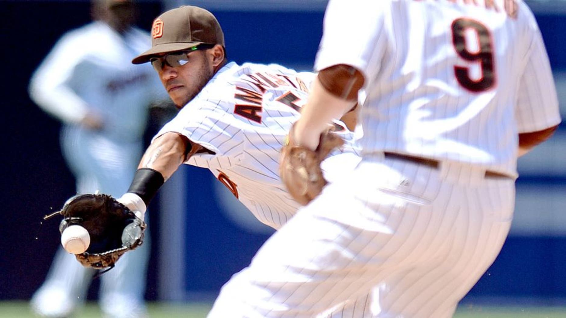 Aug 19, 2015; San Diego, CA, USA; San Diego Padres shortstop Alexi Amarista (5) flips the ball to second baseman Jedd Gyorko (9) on a double play during the sixth inning against the Atlanta Braves at Petco Park. Mandatory Credit: Jake Roth-USA TODAY Sports
