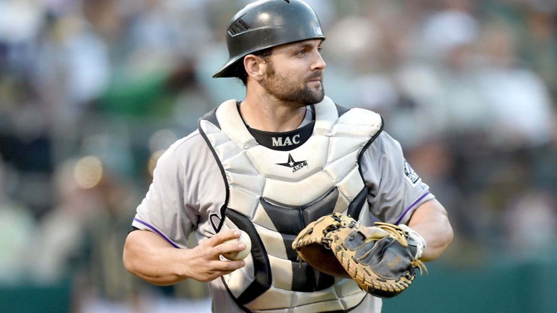 OAKLAND, CA - JUNE 30: Michael McKenry #8 of the Colorado Rockies turns to check the base runner after catching a foul pop-up off the bat of Billy Butler #16 of the Oakland Athletics in the bottom of the fourth inning at O.co Coliseum on June 30, 2015 in Oakland, California. (Photo by Thearon W. Henderson/Getty Images)