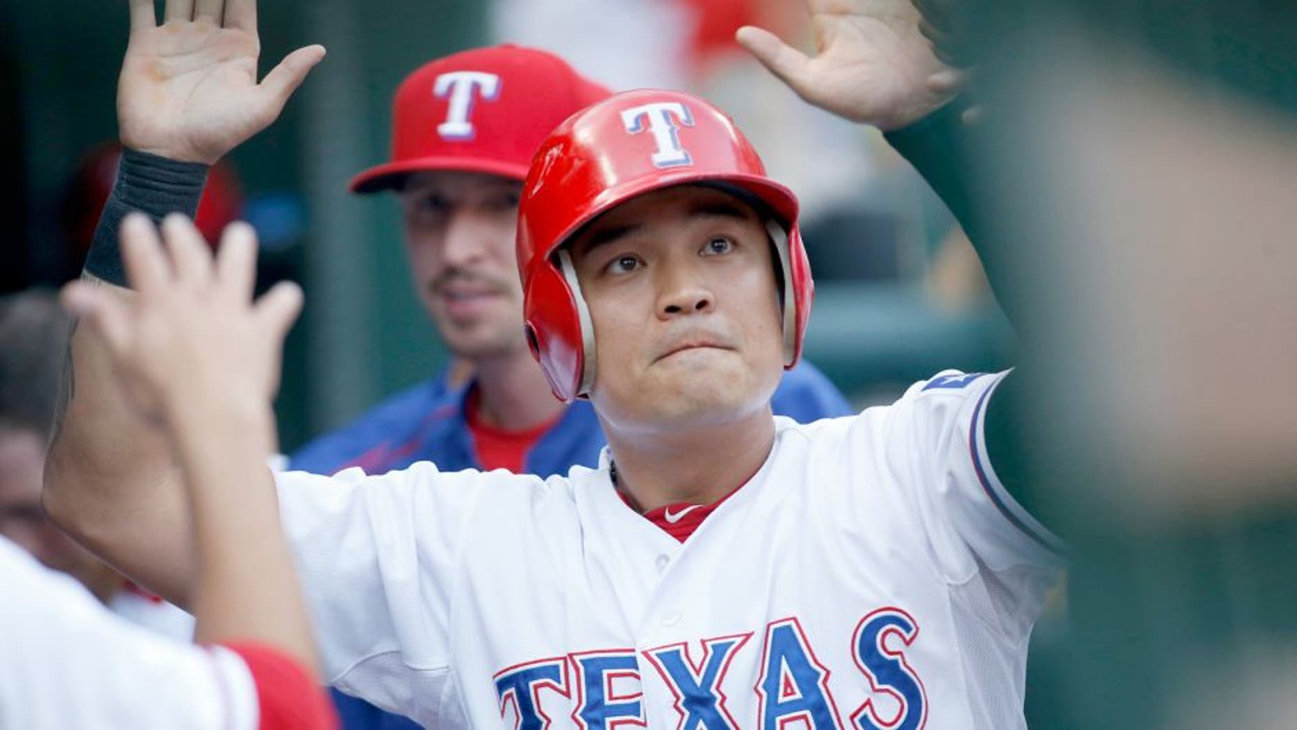 Aug 17, 2015; Arlington, TX, USA; Texas Rangers right fielder Shin-Soo Choo (17) is congratulated by his teammates in the dugout after scoring a run in the first inning against the Seattle Mariners at Globe Life Park in Arlington. Mandatory Credit: Tim Heitman-USA TODAY Sports