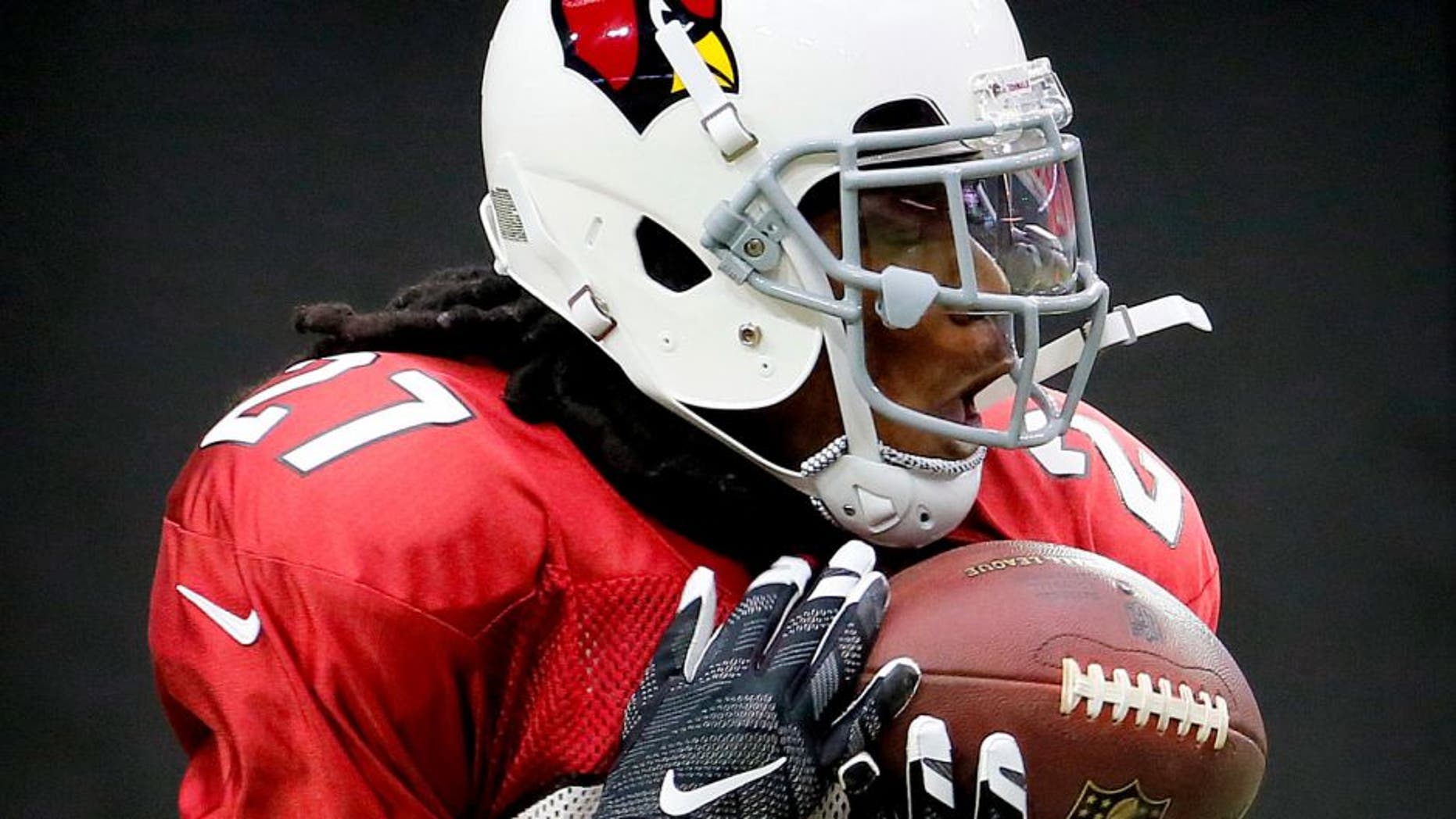 Arizona Cardinals running back Chris Johnson works out during NFL football training camp, Tuesday, Aug. 18, 2015, in Glendale, Ariz. (AP Photo/Matt York)