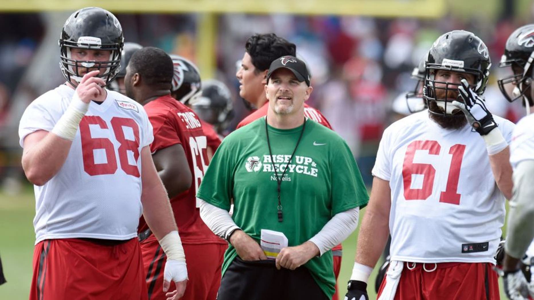 Aug 1, 2015; Atlanta, GA, USA; Atlanta Falcons head coach Dan Quinn shown on the field with players tackle Mike Person (68) and center Joe Hawley (61) during training camp at the Flowery Branch Training Facility. Mandatory Credit: Dale Zanine-USA TODAY Sports