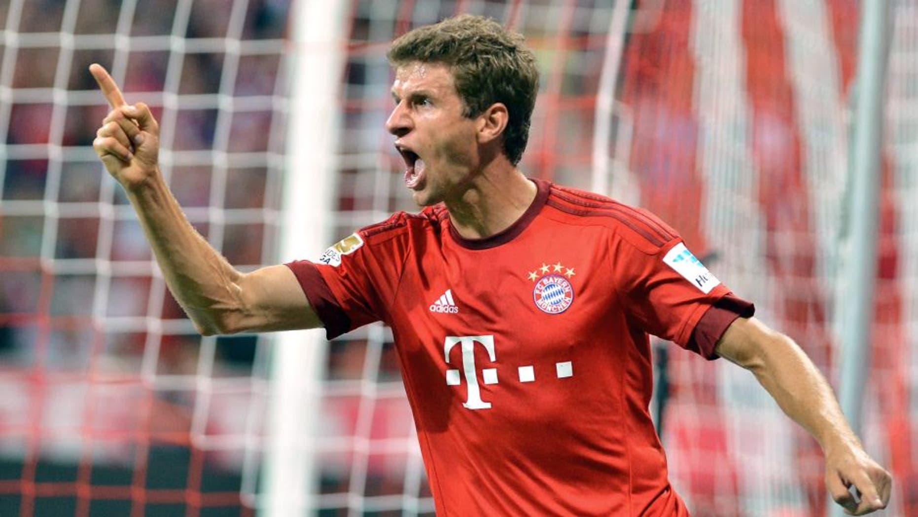 MUNICH, GERMANY - AUGUST 14: Thomas Mueller of Munich celebrates after scoring a goal during the German Bundesliga soccer match between Bayern Munich and Hamburger SV at the Allianz Arena in Munich, Germany on August 14, 2015. (Photo by Joerg Koch/Anadolu Agency/Getty Images)