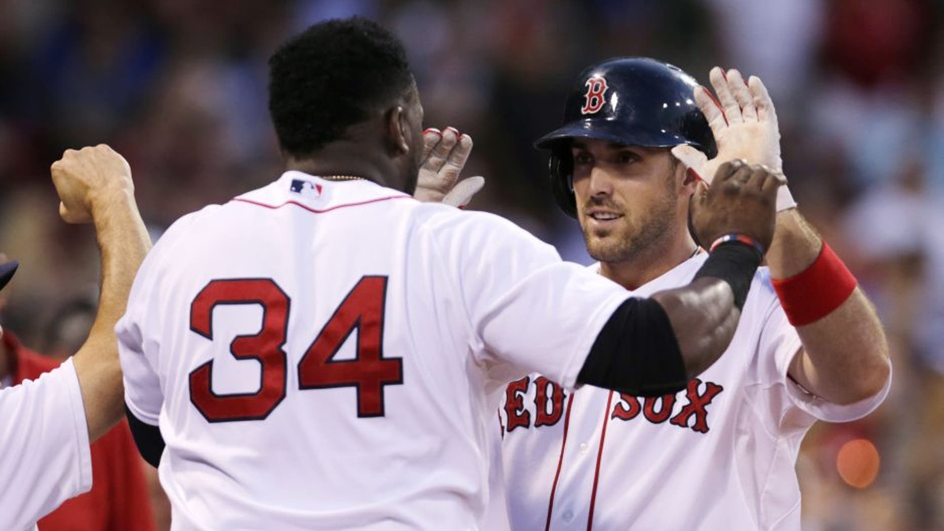 Boston Red Sox's Travis Shaw, right, is congratulated by teammate David Ortiz (34) after their back-to-back home runs off Cleveland Indians starting pitcher Corey Kluber