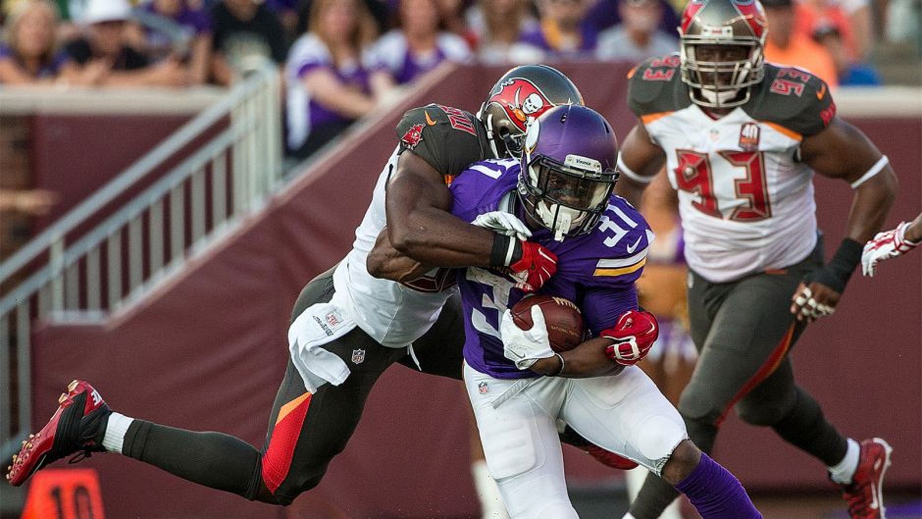 Aug 15, 2015; Minneapolis, MN, USA; Minnesota Vikings running back Jerick McKinnon (31) is tackled by Tampa Bay Buccaneers linebacker Bruce Carter (50) during the first quarter in a preseason NFL football game at TCF Bank Stadium. Mandatory Credit: Brace Hemmelgarn-USA TODAY Sports