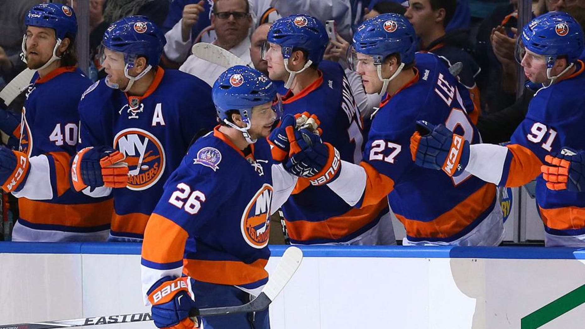 Mar 13, 2015; Uniondale, NY, USA; New York Islanders center Tyler Kennedy (26) high fives the bench after scoringg during the third period against the Ottawa Senators at Nassau Veterans Memorial Coliseum. Ottawa Senators won 2-1. Mandatory Credit: Anthony Gruppuso-USA TODAY Sports