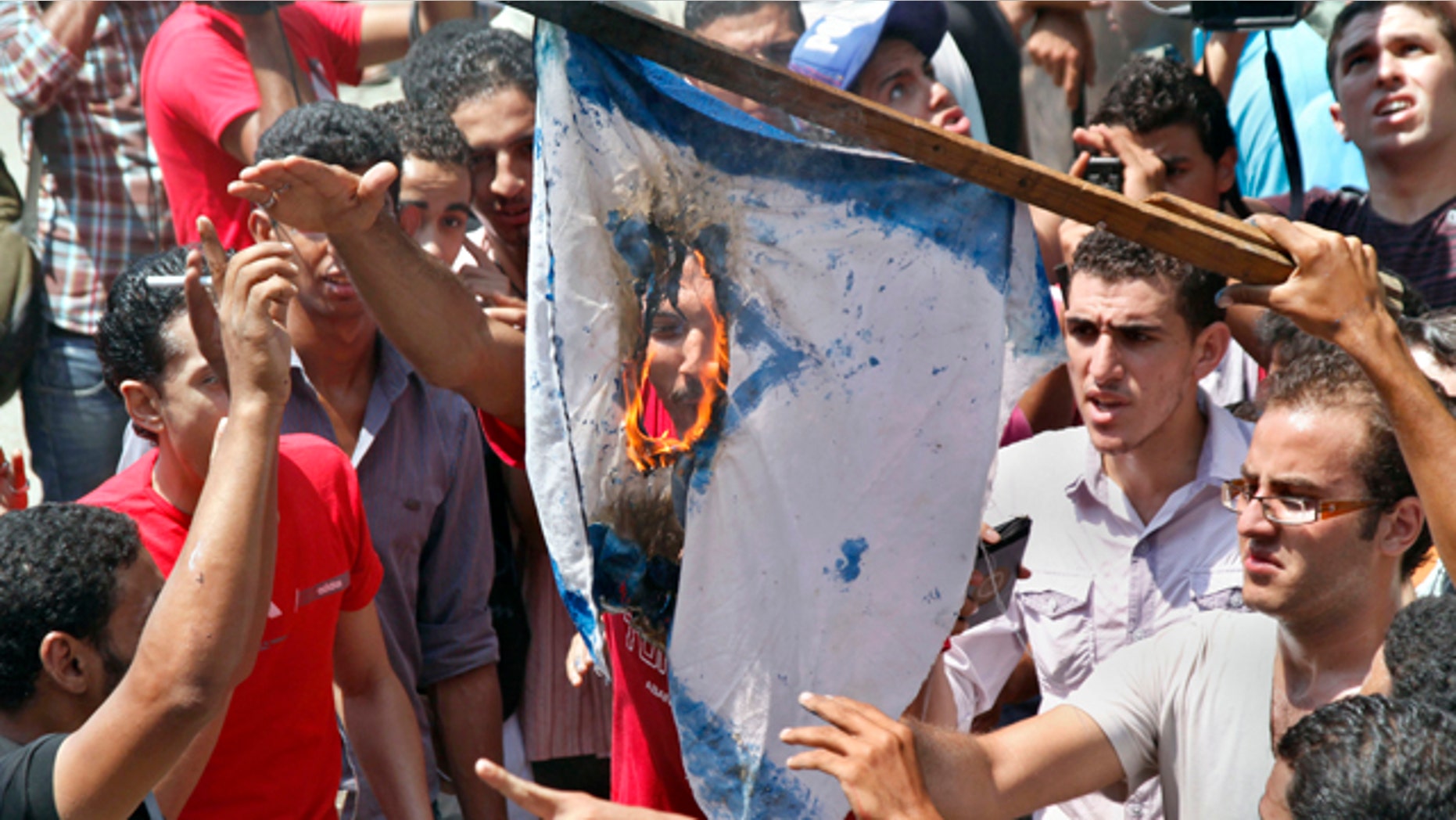 Aug. 20: Egyptian protesters burn an Israeli flag during anti-Israel protest in front of Israeli embassy in Cairo, Egypt, to protest the deaths of Egyptian security forces killed in a shootout between Israeli soldiers and Palestinian militants on Thursday in the Sinai.