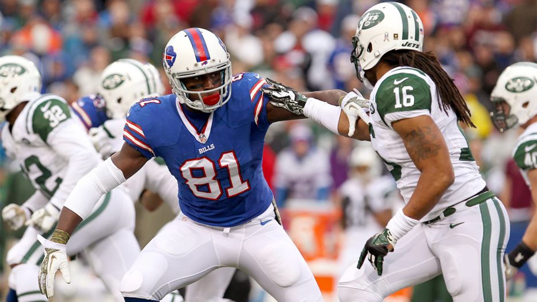 Nov 17, 2013; Orchard Park, NY, USA; Buffalo Bills wide receiver Marcus Easley (81) blocks New York Jets wide receiver Josh Cribbs (16) during the second half at Ralph Wilson Stadium. Bills beat the Jets 37 to 14. Mandatory Credit: Timothy T. Ludwig-USA TODAY Sports