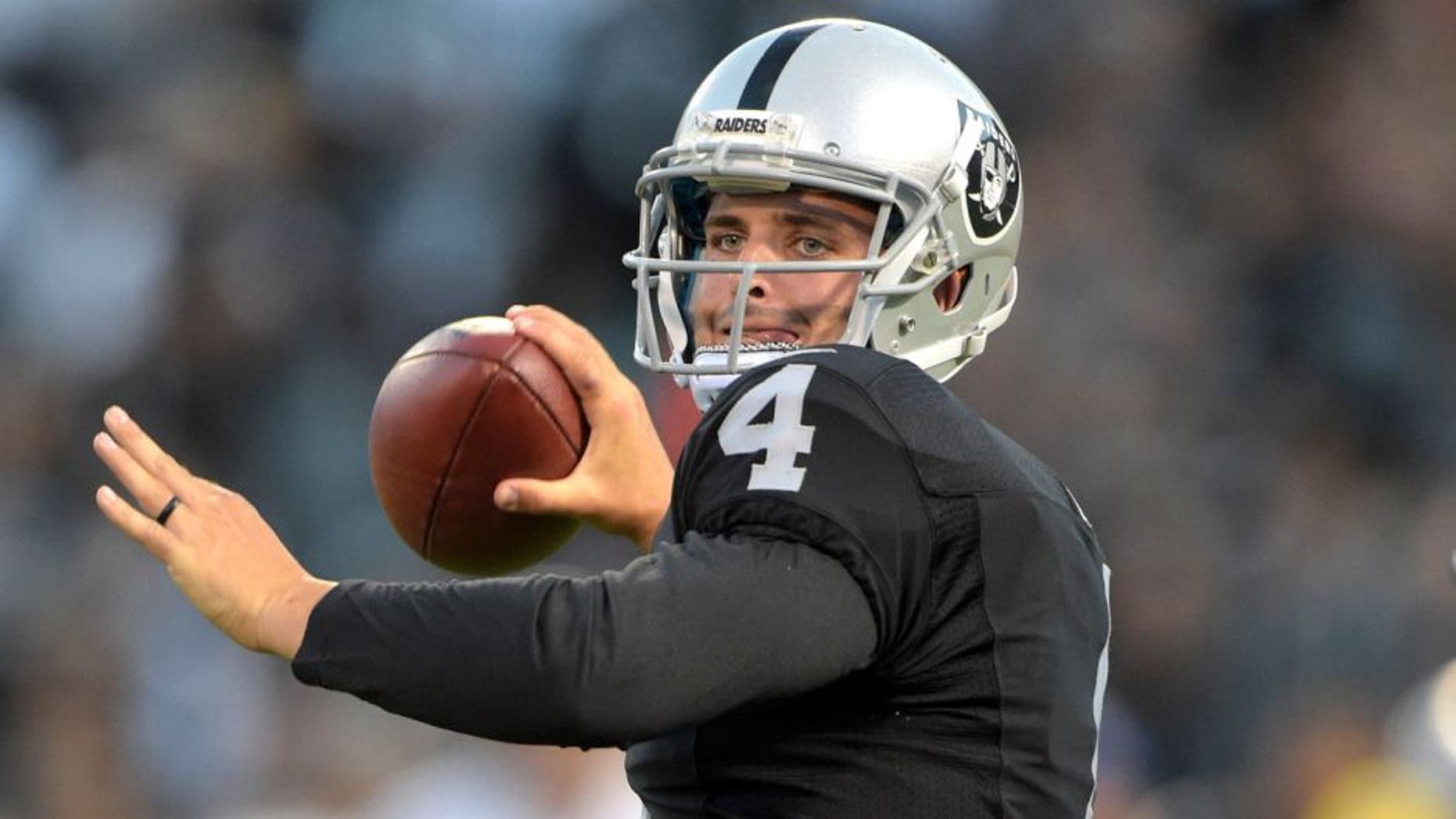 Aug 14, 2015; Oakland, CA, USA; Oakland Raiders quarterback Derek Carr (4) throws a pass against the St. Louis Rams in a preseason NFL football game at O.co Coliseum. Mandatory Credit: Kirby Lee-USA TODAY Sports