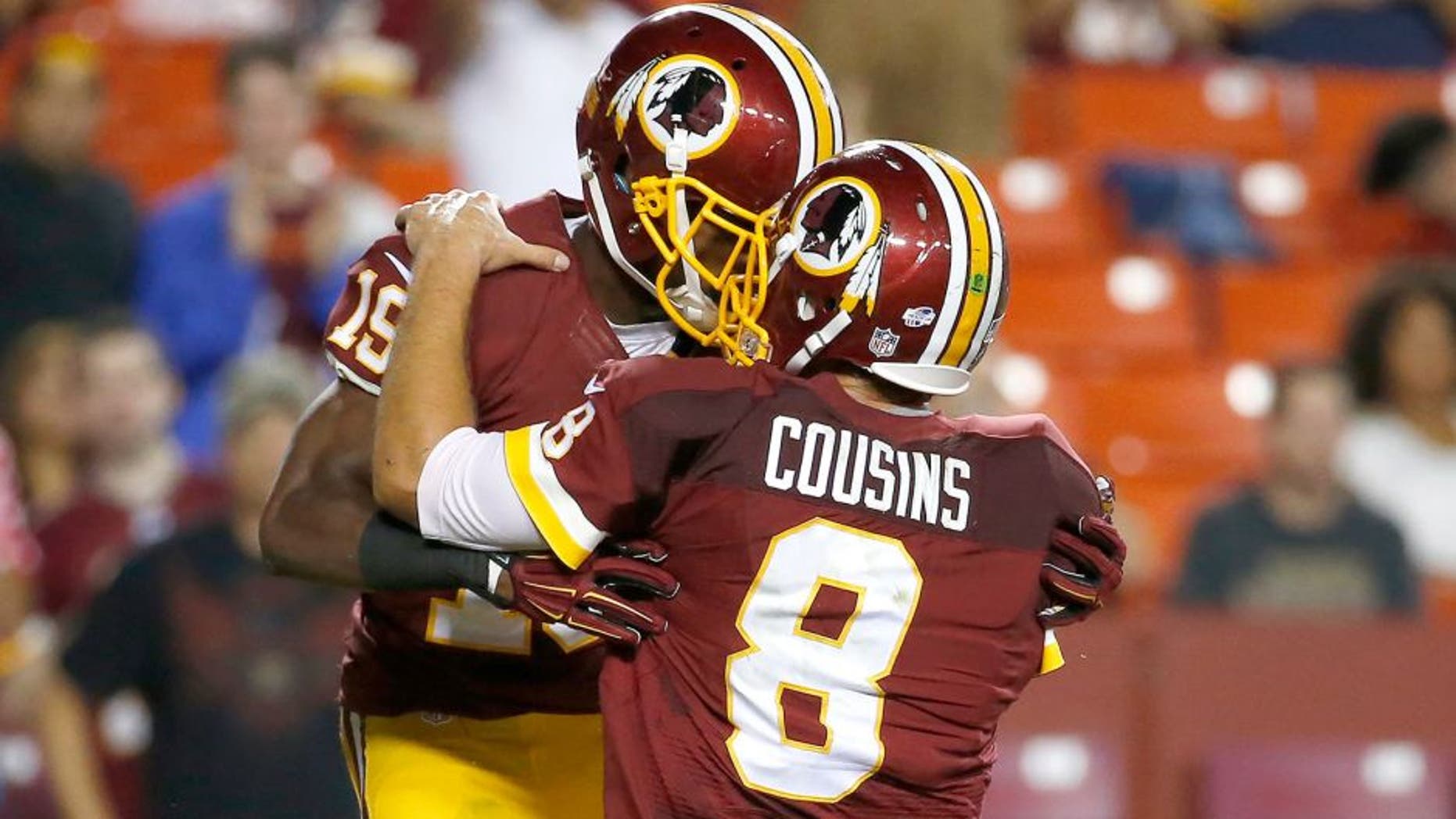 Washington Redskins wide receiver Rashad Ross (19) celebrates his touchdown with quarterback Kirk Cousins (8) during the second half of an NFL preseason football game against the Detroit Lions, Thursday, Aug. 20, 2015, in Landover, Md. (AP Photo/Alex Brandon)