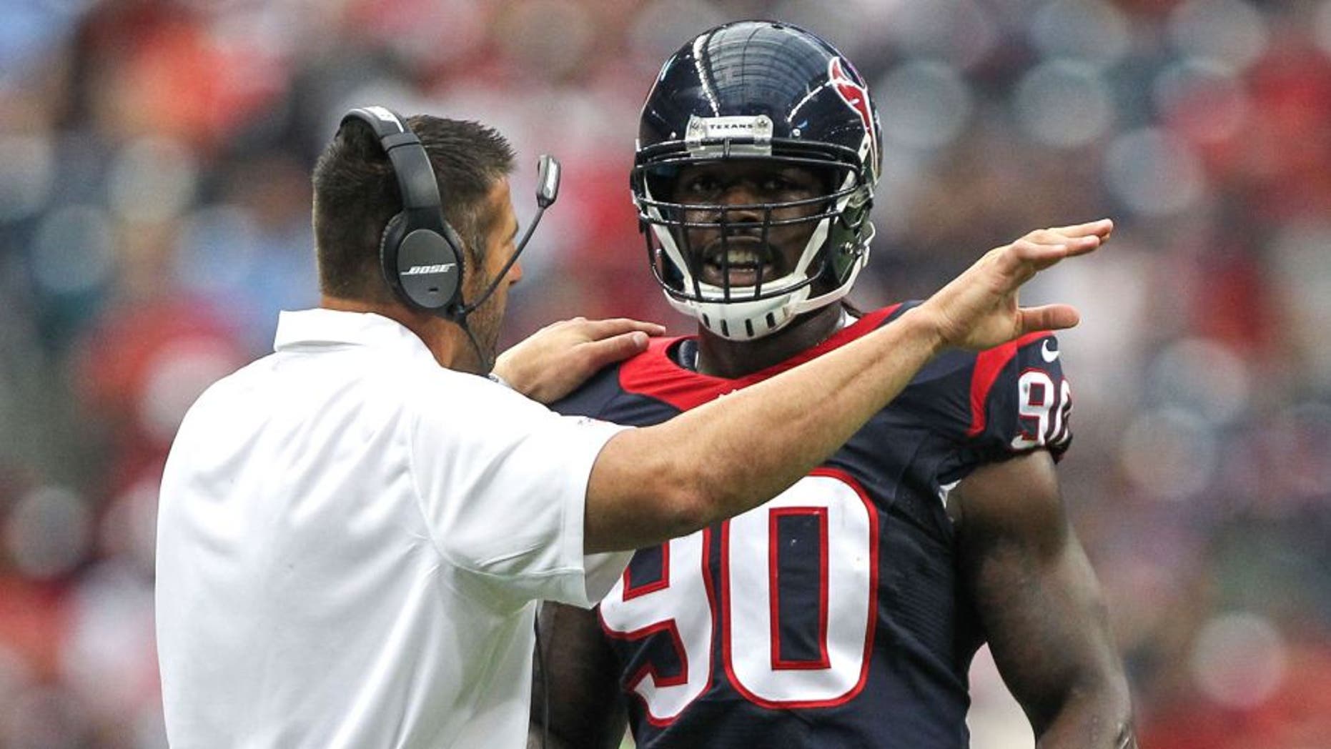 Aug 16, 2014; Houston, TX, USA; Houston Texans linebackers coach Mike Vrabel talks with linebacker Jadeveon Clowney (90) during the first quarter against the Atlanta Falcons at NRG Stadium. Mandatory Credit: Troy Taormina-USA TODAY Sports