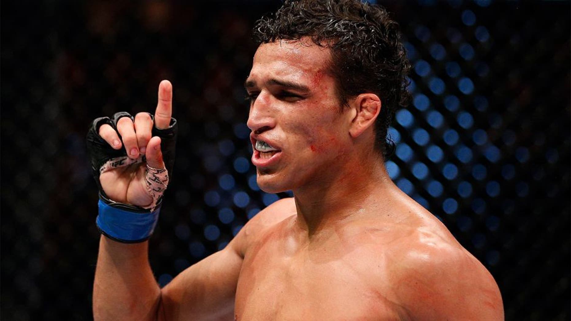 AUCKLAND, NEW ZEALAND - JUNE 28: Charles Oliveira reacts after his submission victory over Hatsu Hioki in their featherweight fight during the UFC Fight Night event at Vector Arena on June 28, 2014 in Auckland, New Zealand. (Photo by Josh Hedges/Zuffa LLC/Zuffa LLC via Getty Images) *** Local Caption *** Charles Oliveira