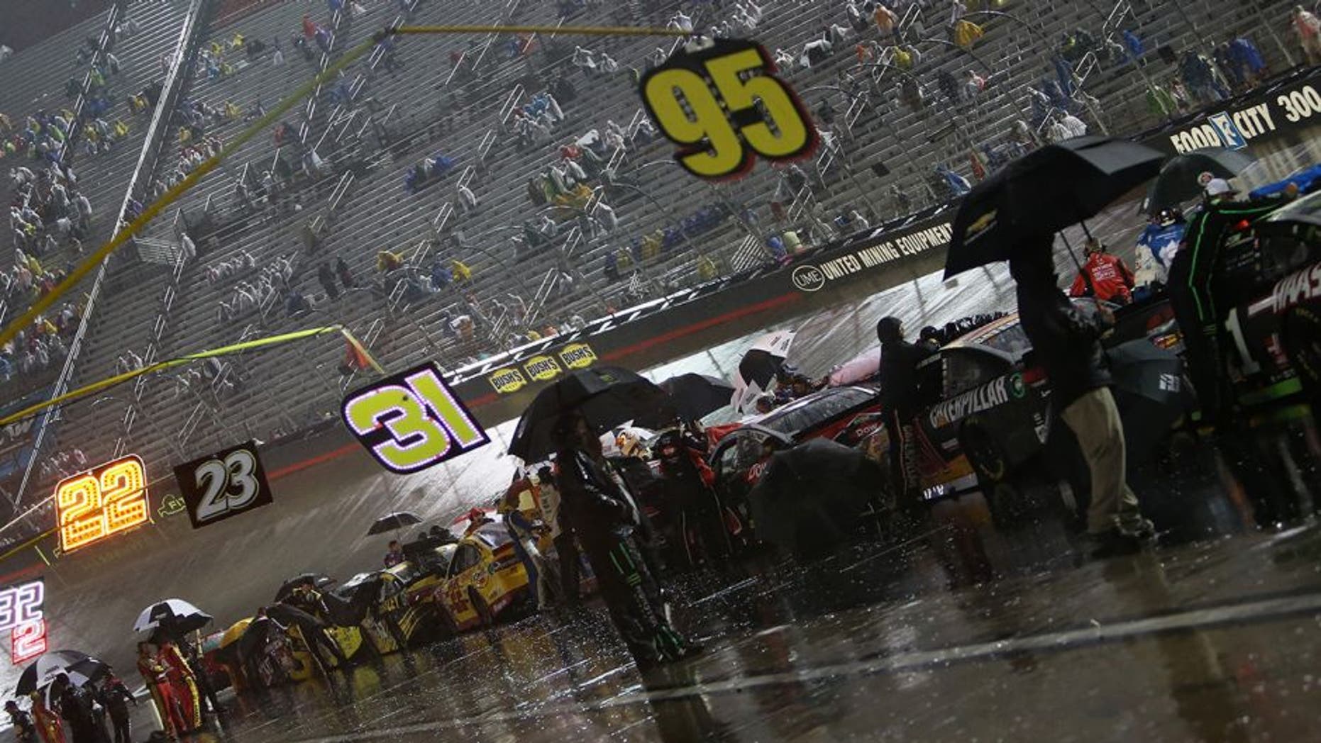 BRISTOL, TN - AUGUST 20: Cars line pit road during the second rain delay of the NASCAR Sprint Cup Series Bass Pro Shops NRA Night Race at Bristol Motor Speedway on August 20, 2016 in Bristol, Tennessee. (Photo by Rey Del Rio/Getty Images)