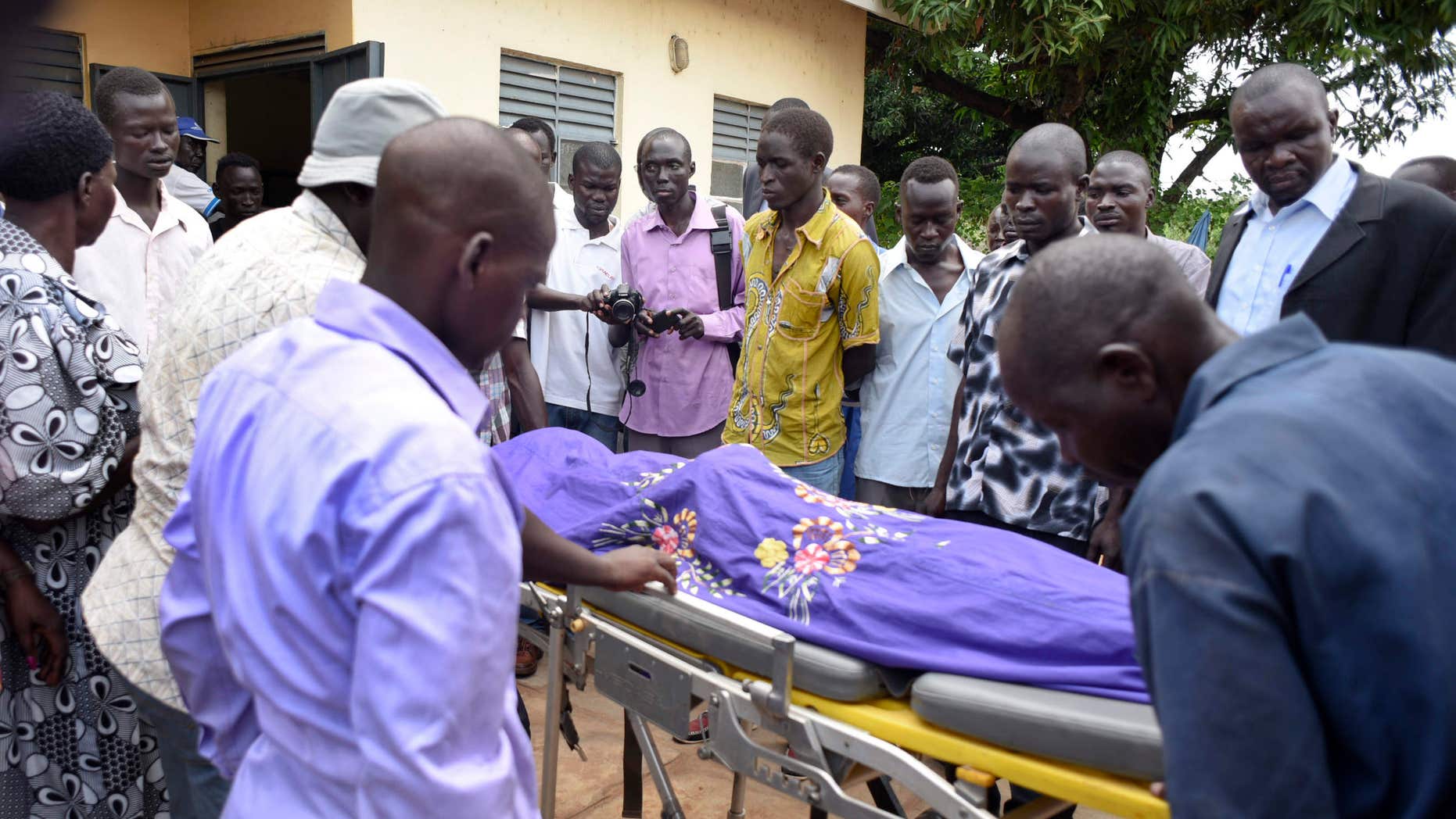 Aug. 20, 2015: Relatives and other mourners watch as the body of South Sudanese journalist Peter Julius Moi is taken into the mortuary in Juba, South Sudan.
