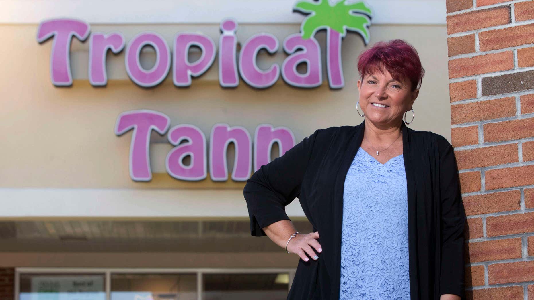 June 17, 2016: Kim Arnold stands for a photo outside her Tropical Tann business in Queensbury, N.Y.