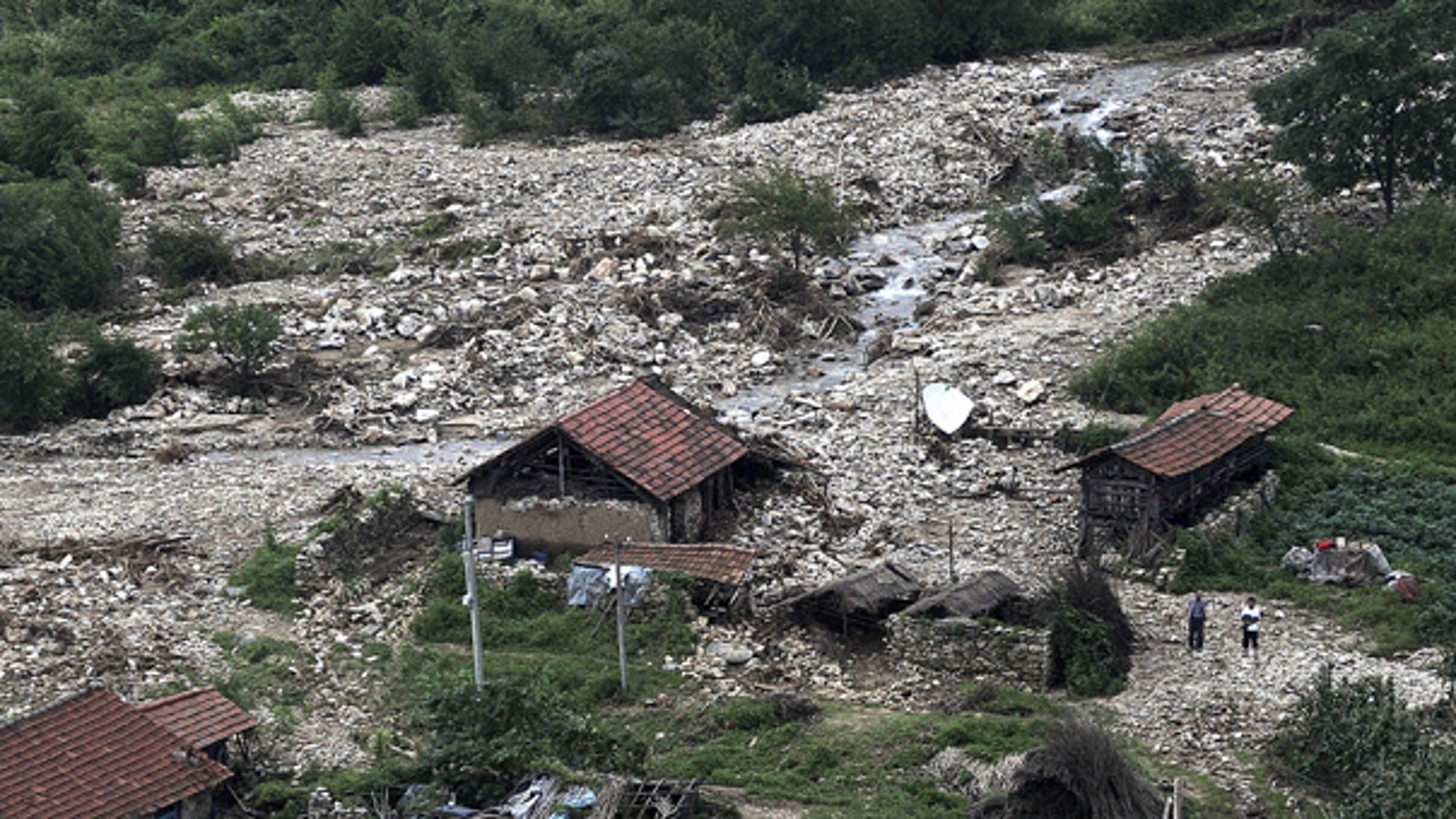Aug. 22: This photo released by China's Xinhua news agency shows the bird's-eye view of a damaged village after flood in northeast China. Flooding has forced the evacuation of 94,000 people in the north China port city of Dandong after heavy rains caused the Yalu river to breach its banks.