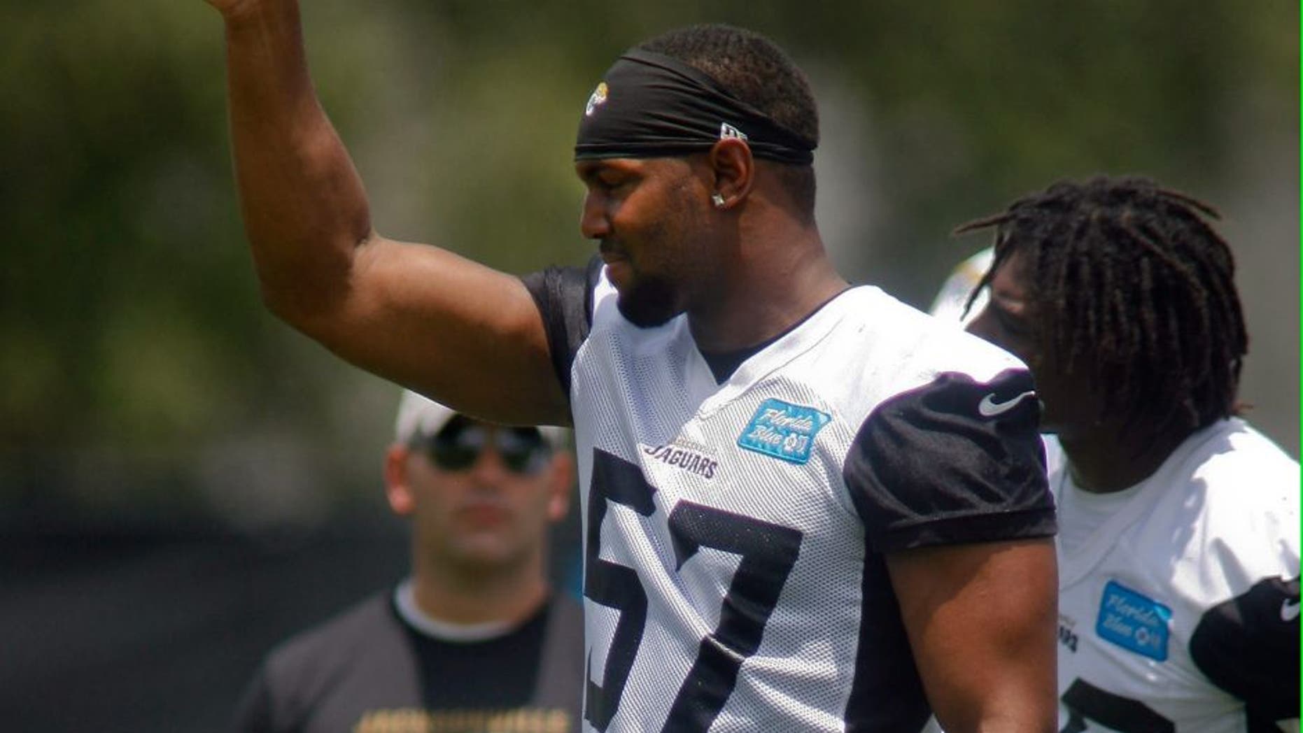 Jun 17, 2014; Jacksonville, FL, USA; Jacksonville Jaguars linebacker Dekoda Watson (57) reacts after a defensive play during the first day of minicamp at Florida Blue Health and Wellness Practice Fields. Mandatory Credit: Phil Sears-USA TODAY Sports