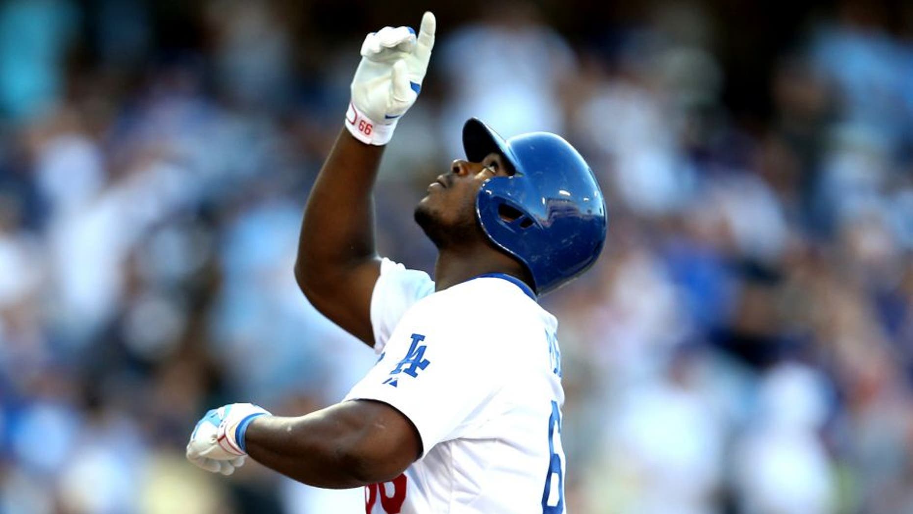 LOS ANGELES, CA - AUGUST 15: Yasiel Puig #66 of the Los Angeles Dodgers celebrates as he crosses home plate after hitting a solo home run in the second inning against the Cincinnati Reds at Dodger Stadium on August 15, 2015 in Los Angeles, California. (Photo by Stephen Dunn/Getty Images)