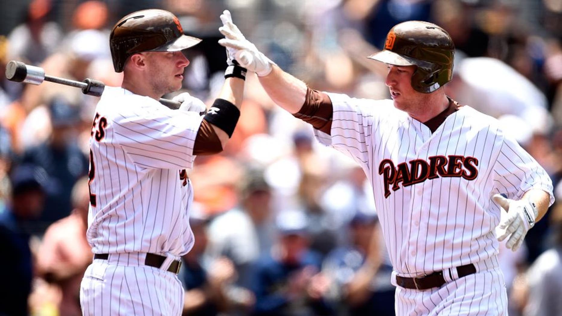 SAN DIEGO, CA - JULY 22: Jedd Gyorko #9 is congratulated by Clint Barmes #12 of the San Diego Padres after hitting a home run during the game against the San Francisco Giants at Petco Park on July 22, 2015 in San Diego, California. (Photo by Andy Hayt/San Diego Padres/Getty Images)