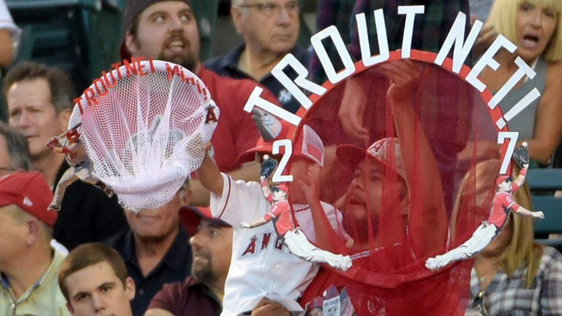 Jun 30, 2015; Anaheim, CA, USA; Fans of Los Angeles Angels center fielder Mike Trout (not pictured) hold a Trout fishing net during the game against the New York Yankees at Angel Stadium of Anaheim. Mandatory Credit: Kirby Lee-USA TODAY Sports