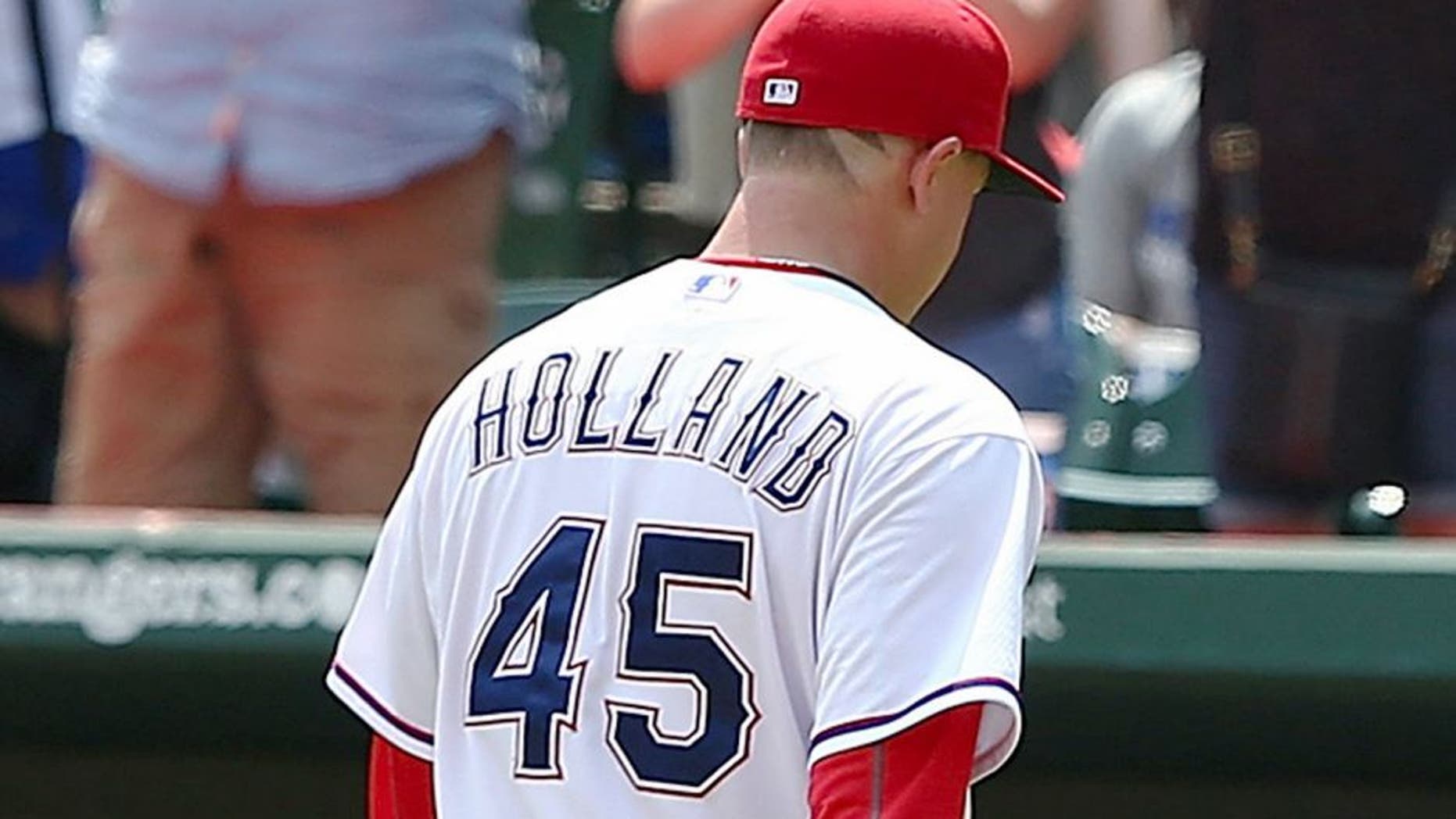 ARLINGTON, TX - AUGUST 19: Fans cheer as Derek Holland #45 of the Texas Rangers leaves the mound after pitching in the seventh inning during a game against the Seattle Mariners at Globe Life Park in Arlington on August 19, 2015 in Arlington, Texas. The Texas Rangers defeated the Seattle Mariners 7-2. (Photo by Sarah Crabill/Getty Images)