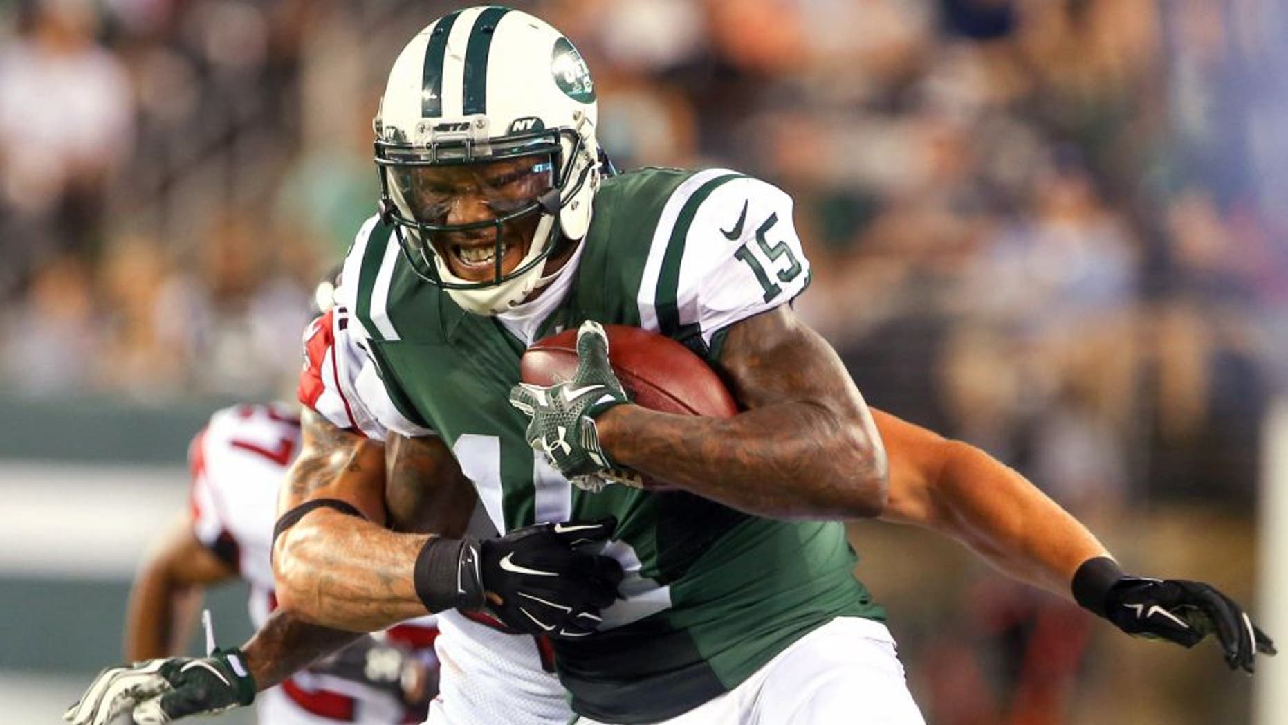 Aug 21, 2015; East Rutherford, NJ, USA; New York Jets wide receiver Brandon Marshall (15) runs with the ball during the first half of their game against the Atlanta Falcons at MetLife Stadium. Mandatory Credit: Ed Mulholland-USA TODAY Sports