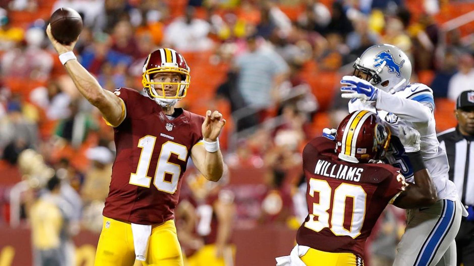 Aug 20, 2015; Landover, MD, USA; Washington Redskins quarterback Colt McCoy (16) throws the ball as Detroit Lions defensive back Isaiah Johnson (43) chases in the third quarter at FedEx Field. The Redskins won 21-17. Mandatory Credit: Geoff Burke-USA TODAY Sports