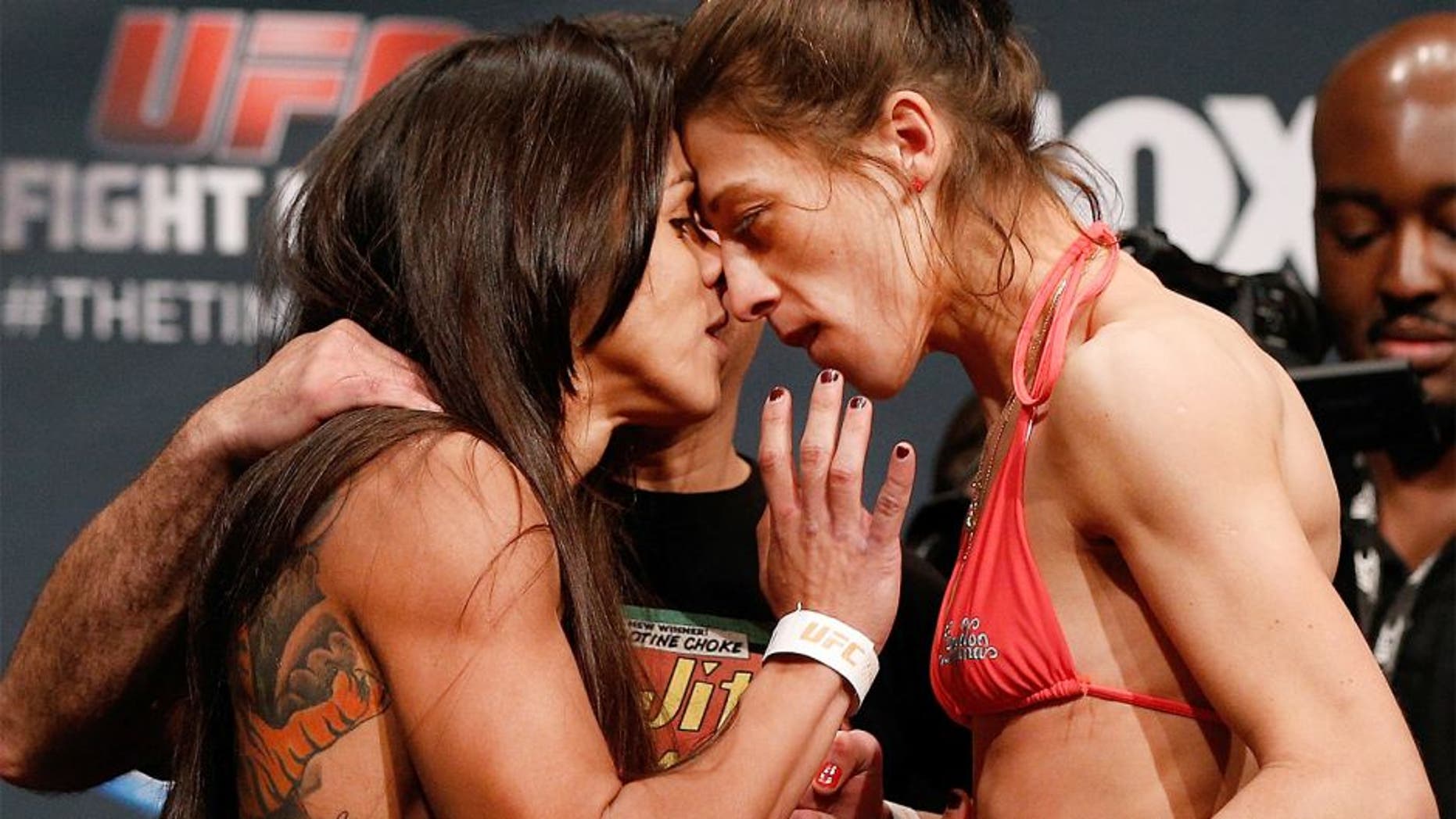 PHOENIX, AZ - DECEMBER 12: (L-R) Opponents Claudia Gadelha of Brazil and Joanna Jedrzejczyk of Poland face off during the UFC Fight Night weigh-in event at the Phoenix Convention Center on December 12, 2014 in Phoenix, Arizona. (Photo by Josh Hedges/Zuffa LLC/Zuffa LLC via Getty Images)