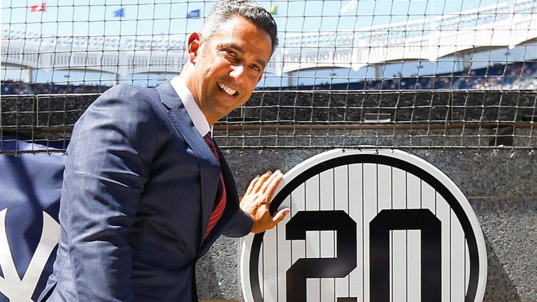NEW YORK, NY - AUGUST 22: Former New York Yankee Jorge Posada poses for a photograph with his retired number plaque in Monument Park during a ceremony before the Yankees play against the Cleveland Indians at Yankee Stadium on August 22, 2015 in the Bronx borough of New York City. (Photo by Jim McIsaac/Getty Images)
