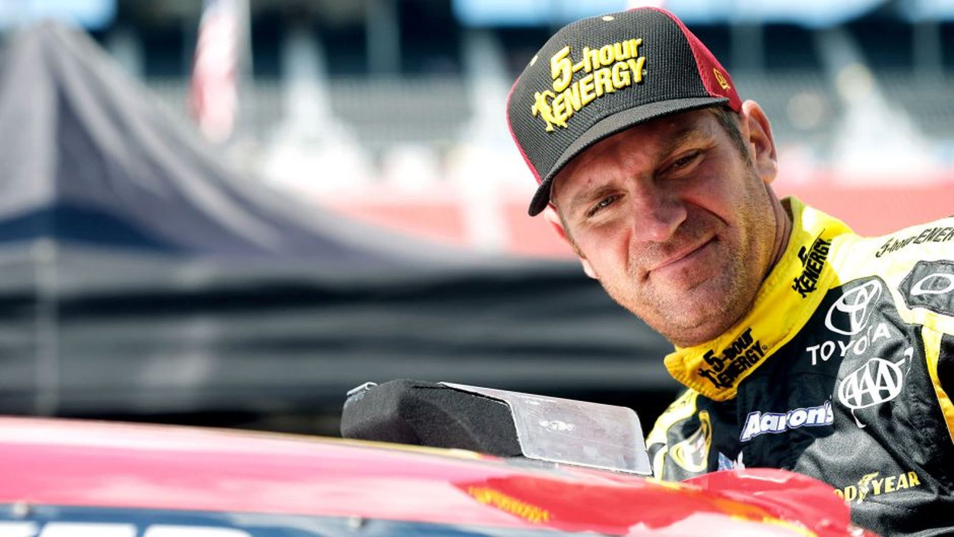 BRISTOL, TN - AUGUST 21: Clint Bowyer, driver of the #15 5-hour Energy Toyota, climbs into his car during practice for the NASCAR Sprint Cup Series Irwin Tools Night Race at Bristol Motor Speedway on August 21, 2015 in Bristol, Tennessee. (Photo by Brian Lawdermilk/Getty Images)