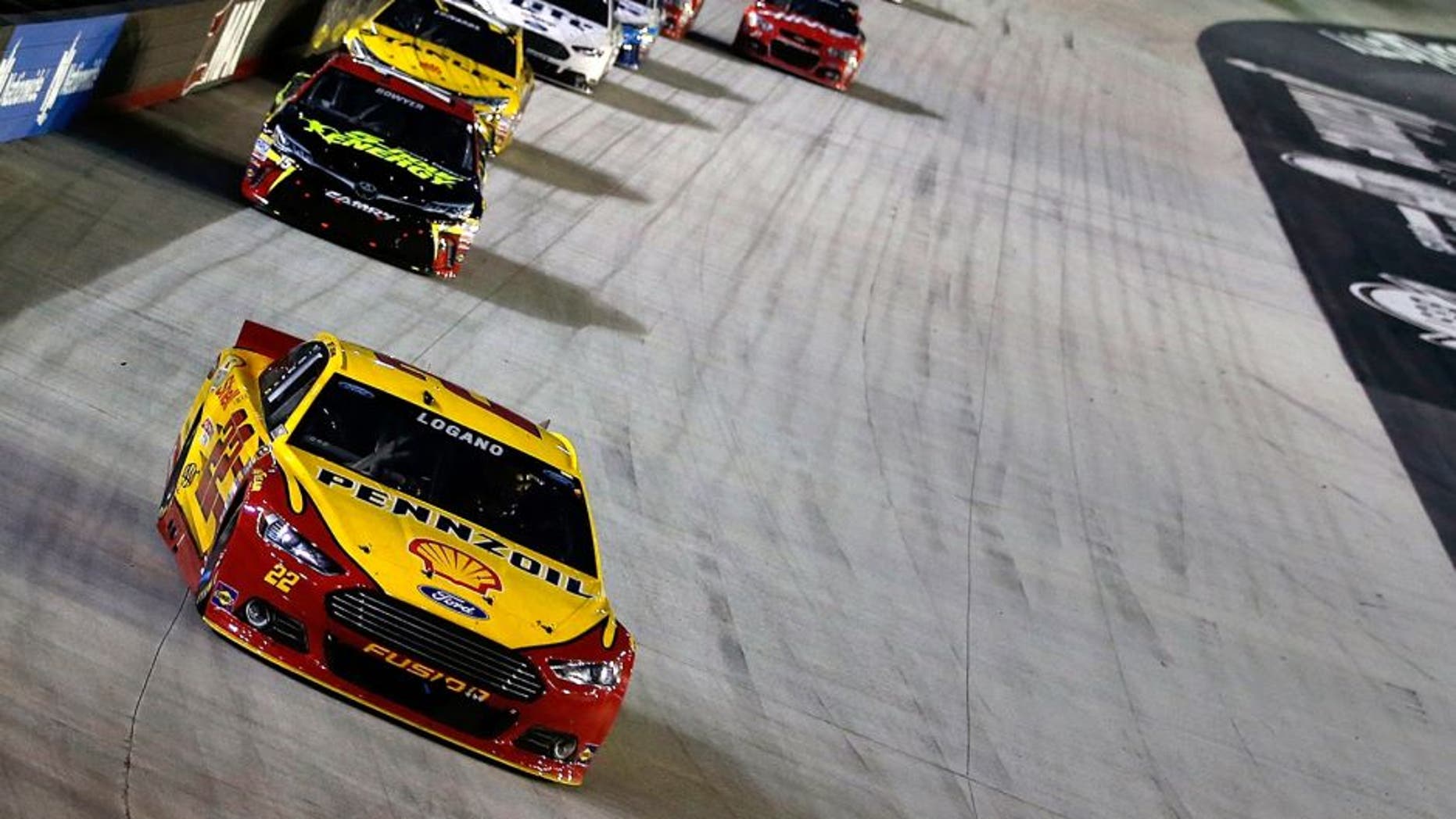 BRISTOL, TN - AUGUST 22: Joey Logano, driver of the #22 Shell Pennzoil Ford, leads a pack of cars during the NASCAR Sprint Cup Series IRWIN Tools Night Race at Bristol Motor Speedway on August 22, 2015 in Bristol, Tennessee. (Photo by Gregory Shamus/Getty Images)