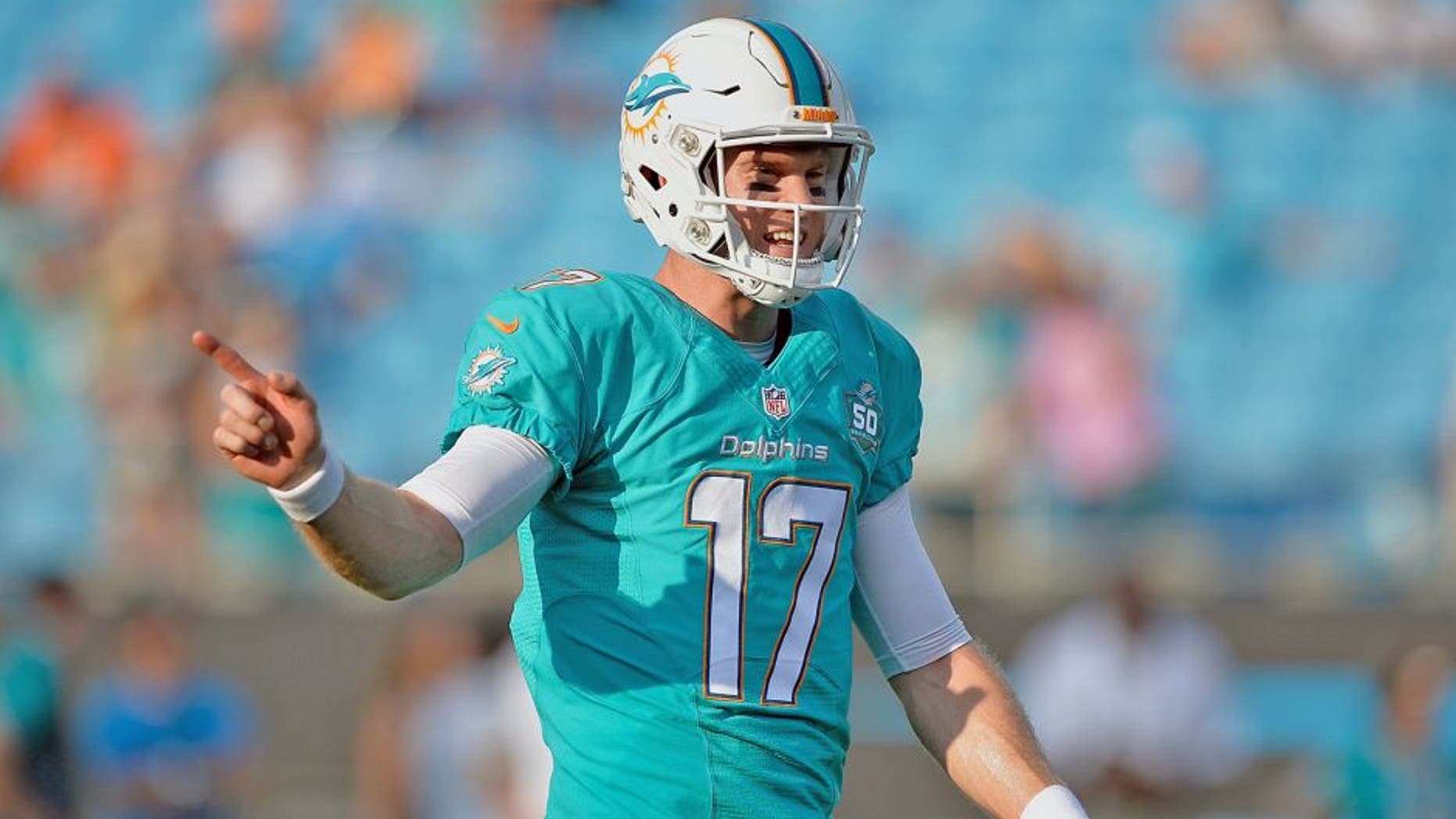 CHARLOTTE, NC - AUGUST 22: Ryan Tannehill #17 of the Miami Dolphins directs his teammates during their preseason NFL game against the Carolina Panthers at Bank of America Stadium on August 22, 2015 in Charlotte, North Carolina. (Photo by Grant Halverson/Getty Images)