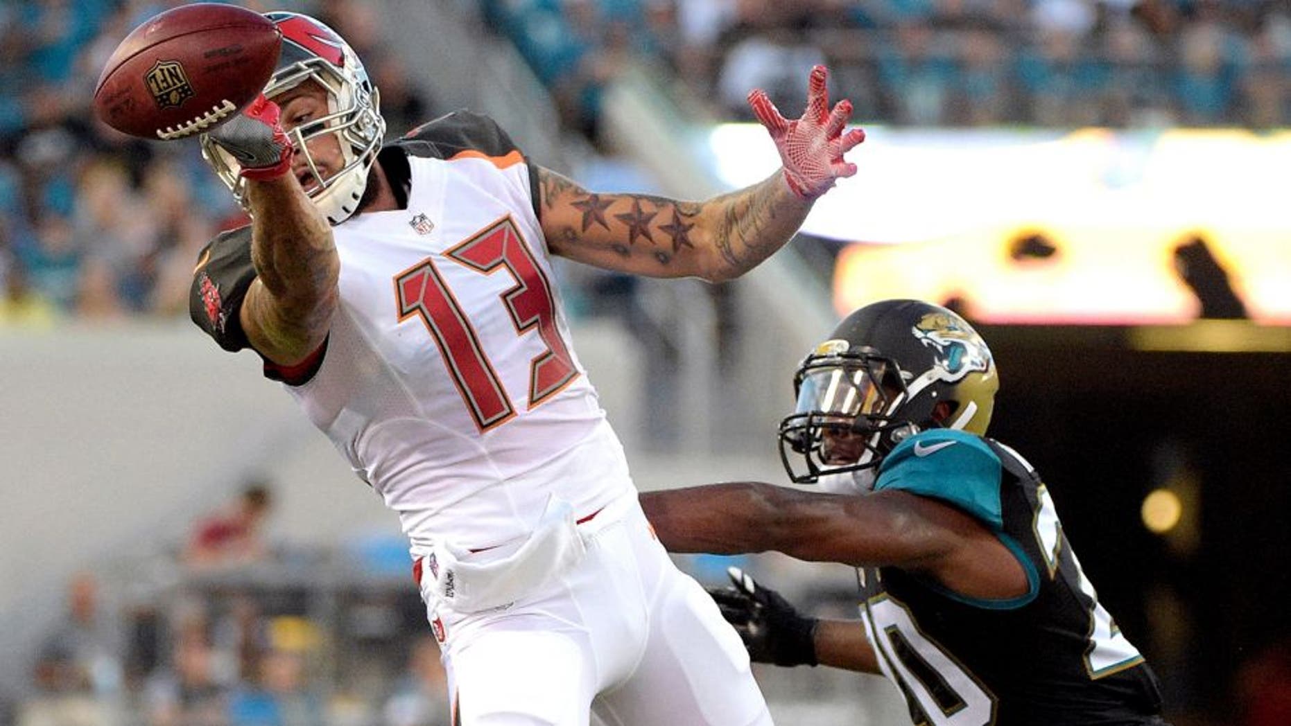 Tampa Bay Buccaneers wide receiver Mike Evans (13) cannot make a reception while defended by Jacksonville Jaguars cornerback Jalen Ramsey (20) during the first half of an NFL preseason football game in Jacksonville, Fla., Saturday, Aug. 20, 2016. (AP Photo/Phelan M. Ebenhack)