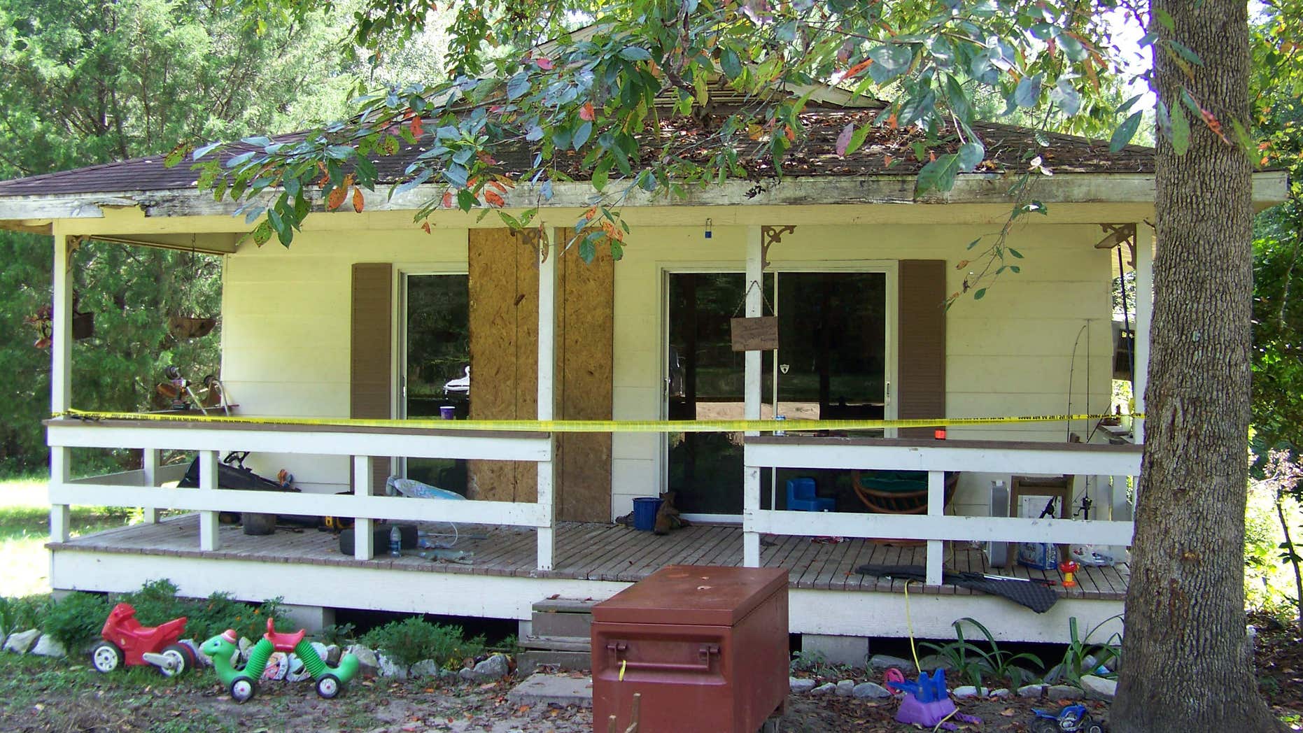 Crime scene tape marks the home on Jim Platt Road near Citronelle, Ala., Sunday, Aug. 21, 2016, where authorities said five people were killed on Saturday.