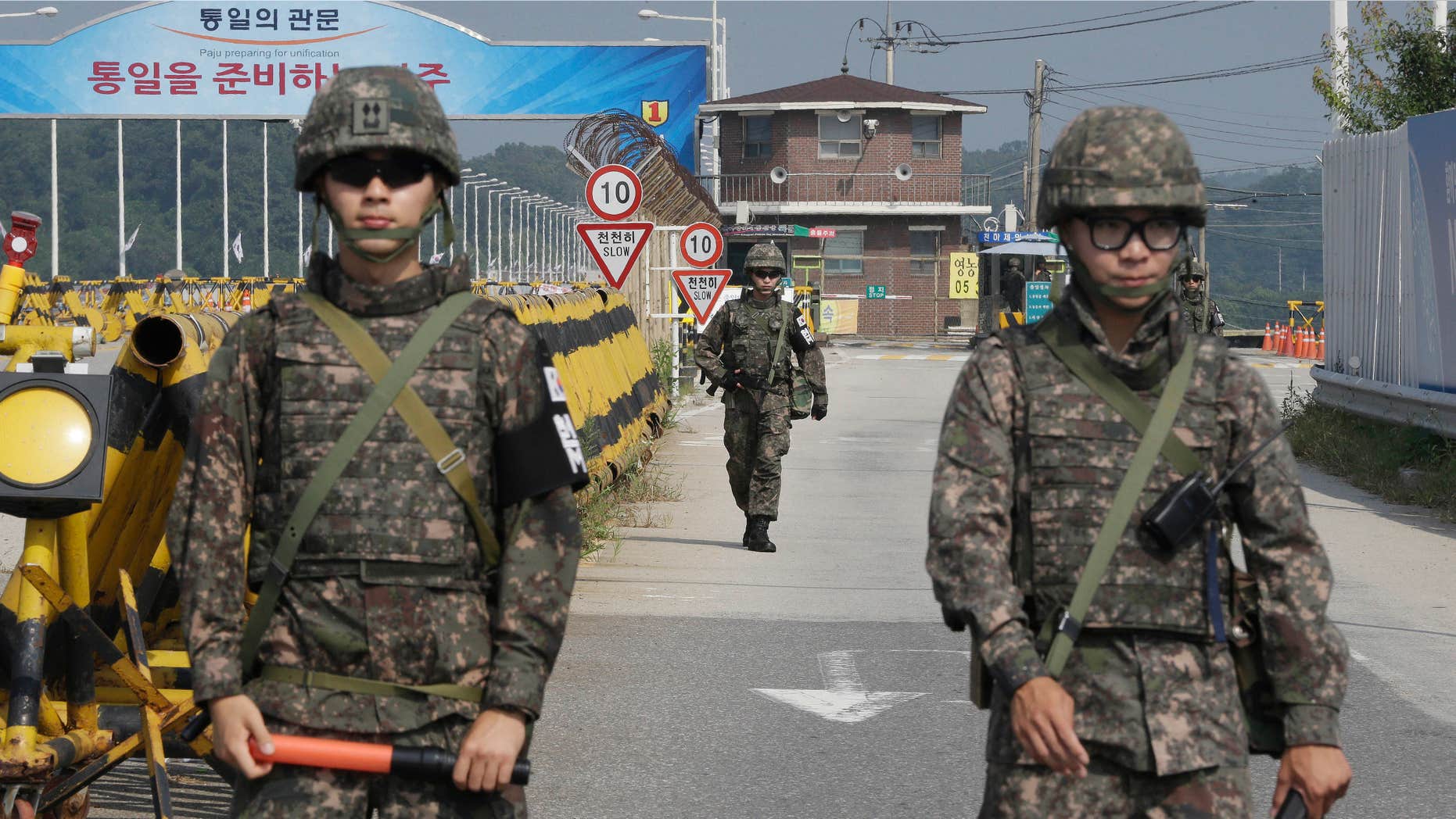Aug. 23, 2015: A South Korean amy soldier walks as his colleague soldiers stand guard on Unification Bridge, which leads to the demilitarized zone, near the border village of Panmunjom in Paju, South Korea.