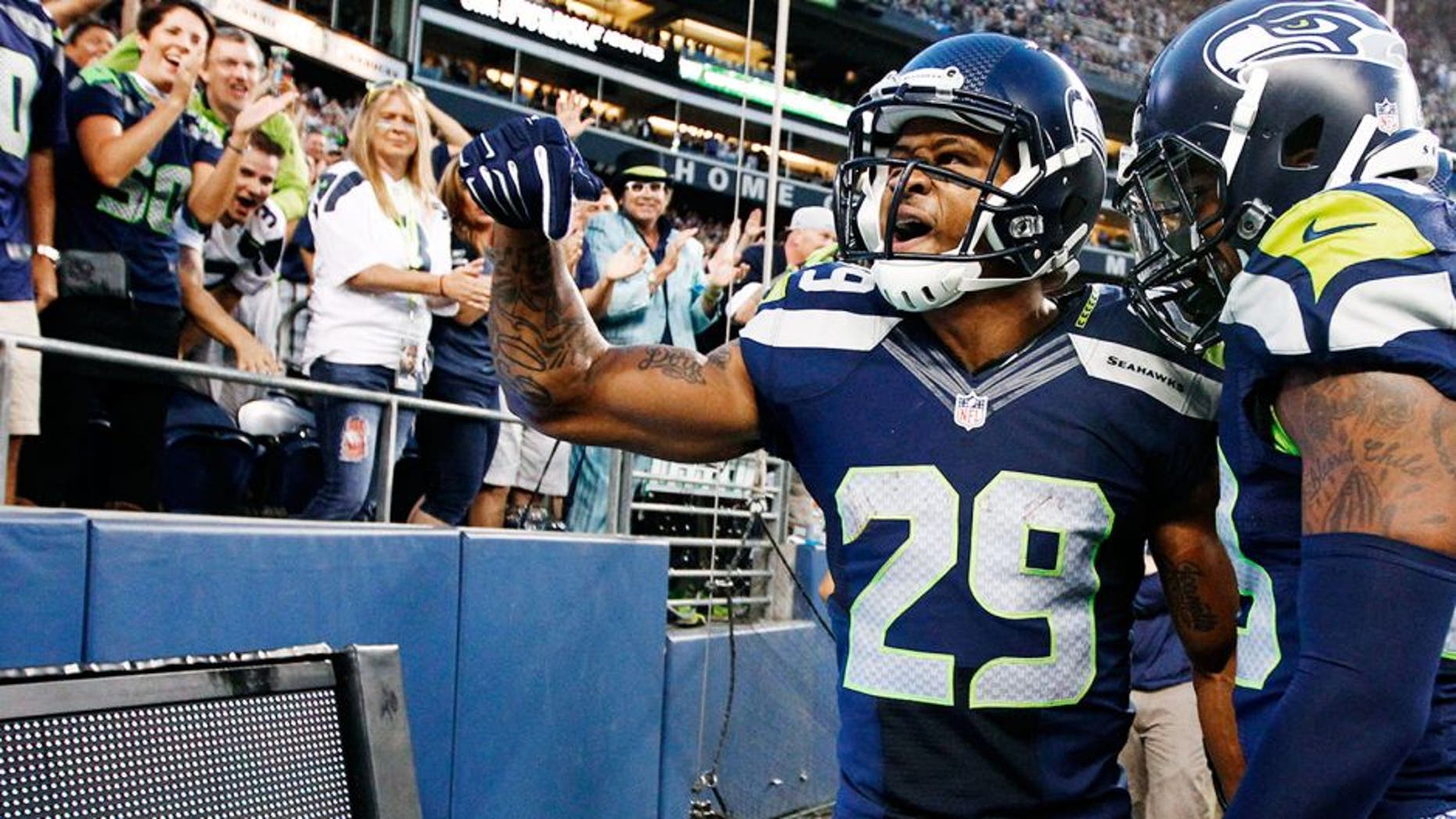 Aug 22, 2014; Seattle, WA, USA; Seattle Seahawks free safety Earl Thomas (29) celebrates after a 59-yard punt return against the Chicago Bears during the second quarter at CenturyLink Field. Seattle Seahawks strong safety Jeron Johnson (23) is at right. Mandatory Credit: Joe Nicholson-USA TODAY Sports