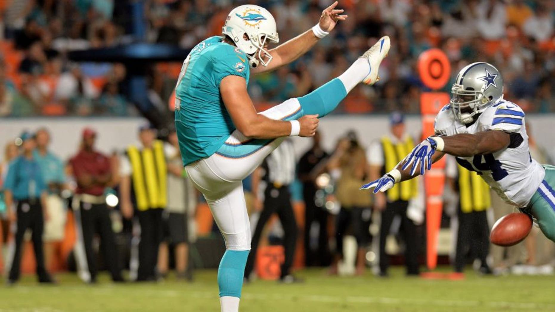 Aug 23, 2014; Miami Gardens, FL, USA; Dallas Cowboys outside linebacker Bruce Carter (54) blocks the punt of Miami Dolphins punter Brandon Fields (2) during the first half at Sun Life Stadium. Mandatory Credit: Steve Mitchell-USA TODAY Sports