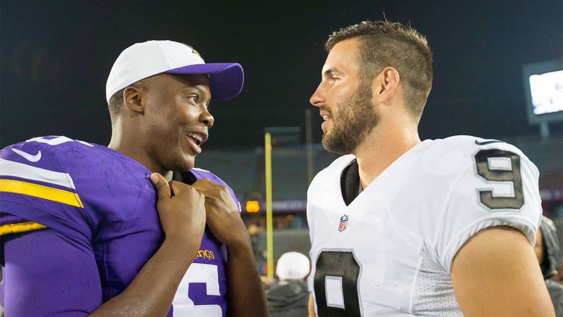 Aug 22, 2015; Minneapolis, MN, USA; Minnesota Vikings quarterback Teddy Bridgewater (5) and Oakland Raiders quarterback Christian Ponder (9) talk after the game at TCF Bank Stadium. The Minnesota Vikings beat the Oakland Raiders 20-12. Mandatory Credit: Brad Rempel-USA TODAY Sports