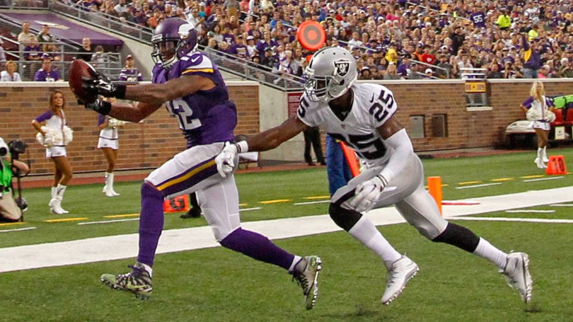 Aug 22, 2015; Minneapolis, MN, USA; Minnesota Vikings wide receiver Charles Johnson (12) catches a pass past Oakland Raiders cornerback D.J. Hayden (25) for a touchdown in the second quarter at TCF Bank Stadium. Mandatory Credit: Bruce Kluckhohn-USA TODAY Sports