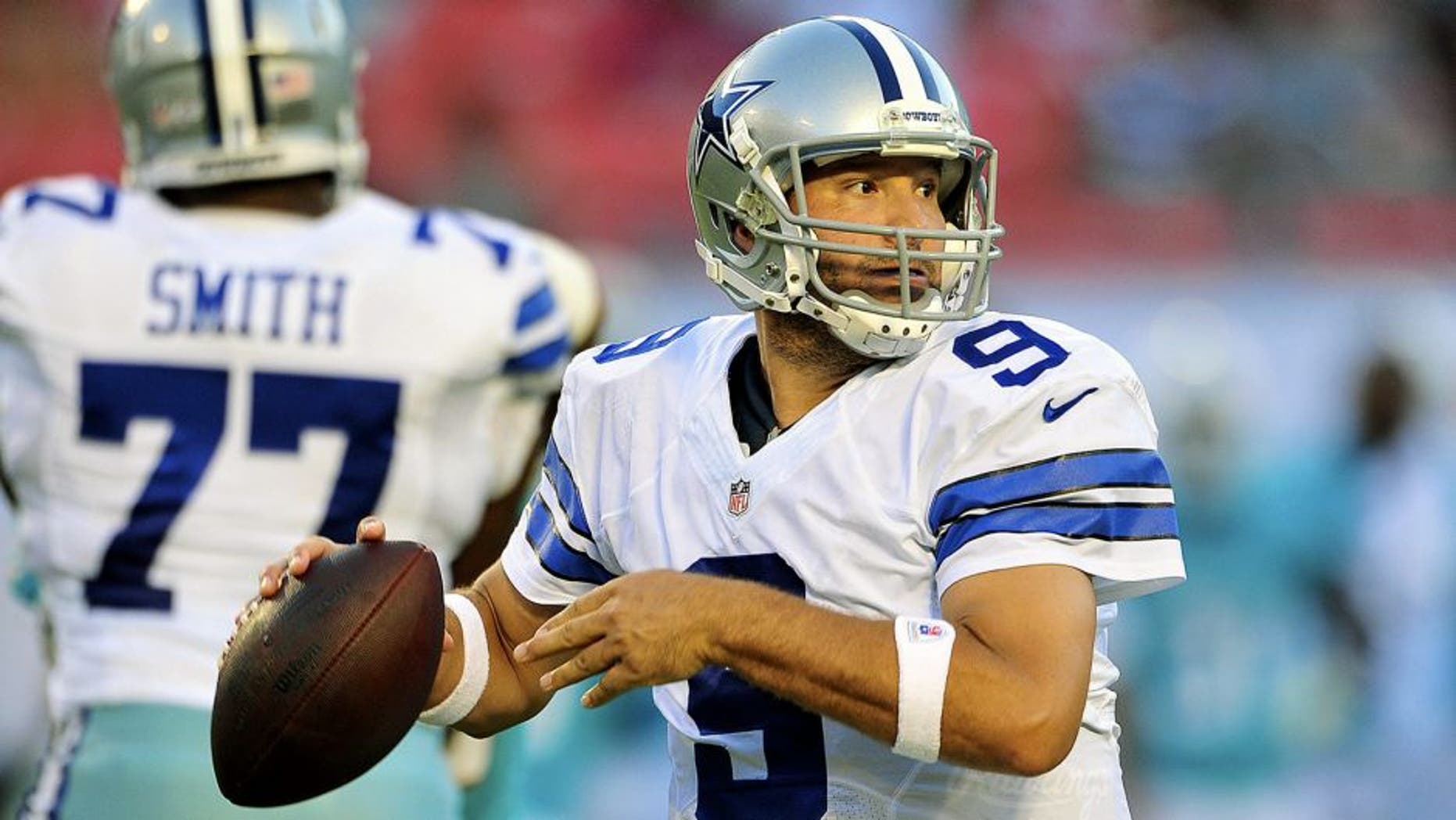 MIAMI GARDENS, FL - AUGUST 23: Quarterback Tony Romo #9 of the Dallas Cowboys looks for a receiver during a preseason game against the Miami Dolphins at Sun Life Stadium on August 23, 2014 in Miami Gardens, Florida. (Photo by Ronald C. Modra/Sports Imagery/ Getty Images)