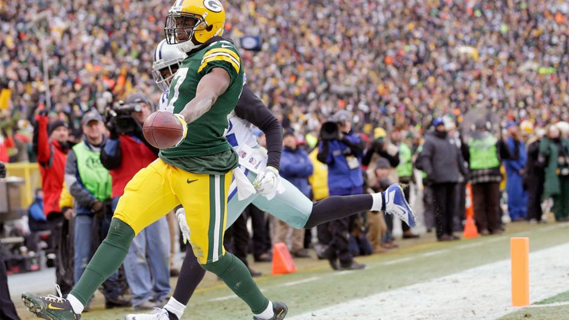 Jan 11, 2015; Green Bay, WI, USA; Green Bay Packers wide receiver Davante Adams (17) scores a touchdown against the Dallas Cowboys in the third quarter in the 2014 NFC Divisional playoff football game at Lambeau Field. Mandatory Credit: Jeff Hanisch-USA TODAY Sports