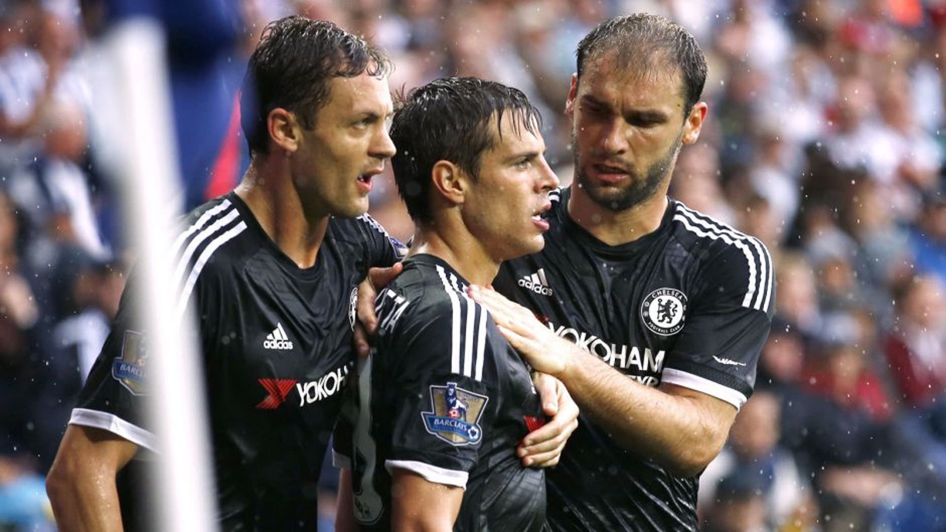 Chelsea's Spanish defender Cesar Azpilicueta (2nd R) celebrates with Chelsea's Serbian midfielder Nemanja Matic and Chelsea's Serbian defender Branislav Ivanovic (R) after scoring their third goal during the English Premier League football match between West Bromwich Albion and Chelsea at The Hawthorns in West Bromwich, central England on August 23, 2015. AFP PHOTO / JUSTIN TALLIS RESTRICTED TO EDITORIAL USE. No use with unauthorized audio, video, data, fixture lists, club/league logos or 'live' services. Online in-match use limited to 75 images, no video emulation. No use in betting, games or single club/league/player publications. (Photo credit should read JUSTIN TALLIS/AFP/Getty Images)