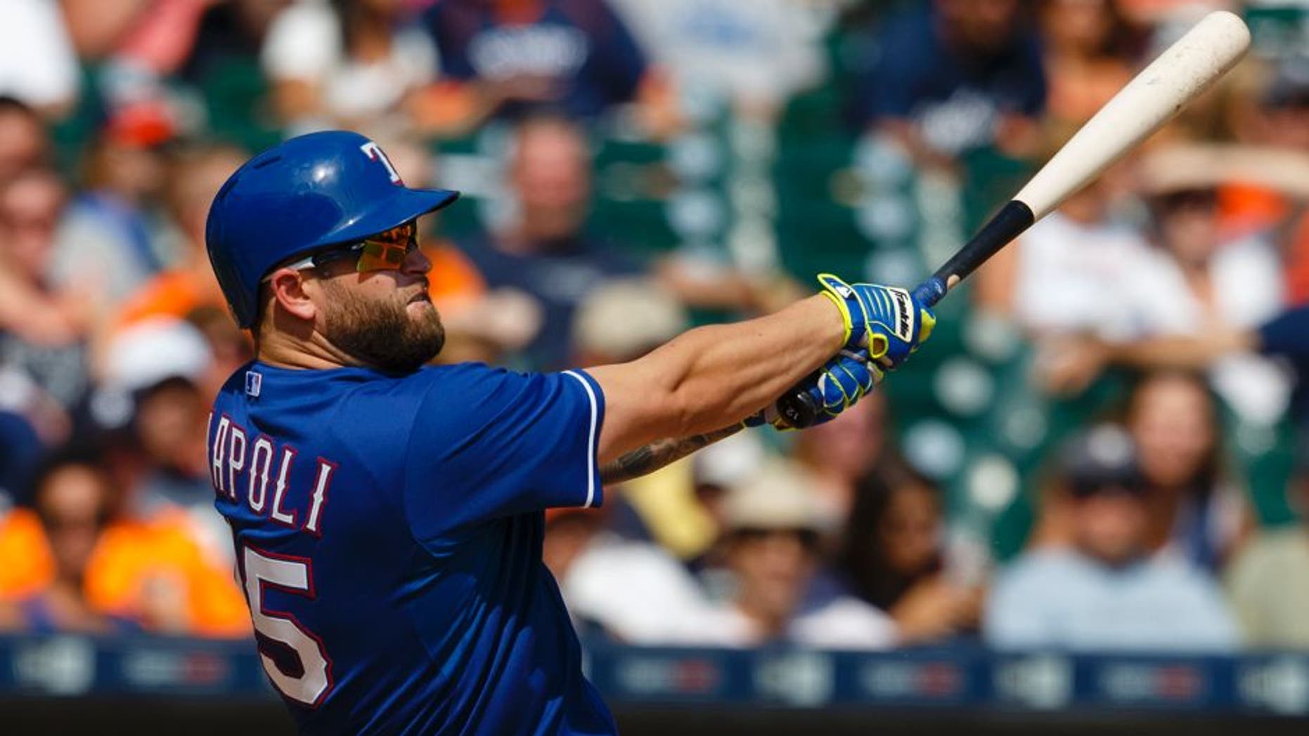 Aug 23, 2015; Detroit, MI, USA; Texas Rangers designated hitter Mike Napoli (25) hits a home run in the eighth inning against the Detroit Tigers at Comerica Park. Mandatory Credit: Rick Osentoski-USA TODAY Sports